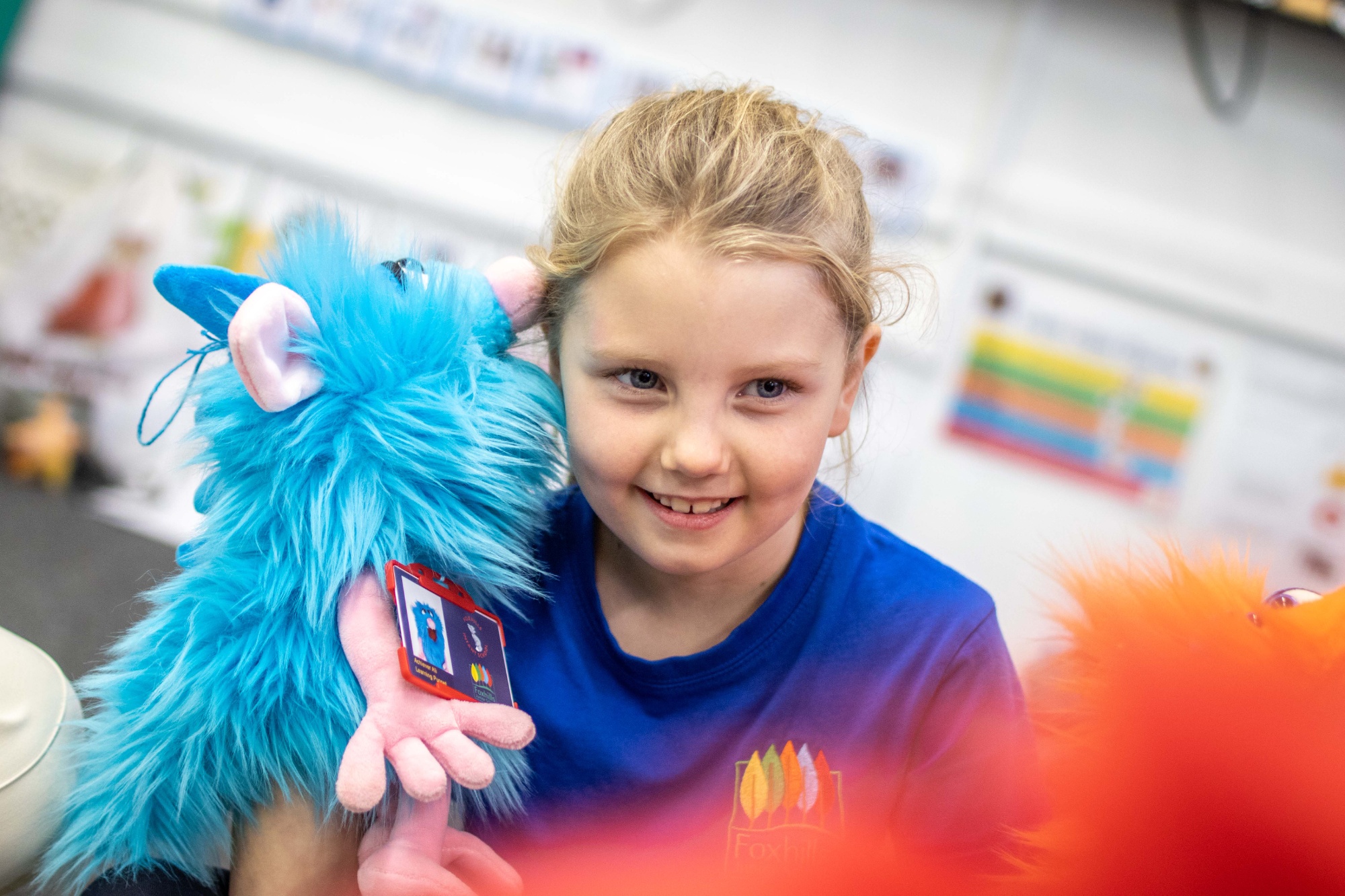 A girl talks to a puppet.