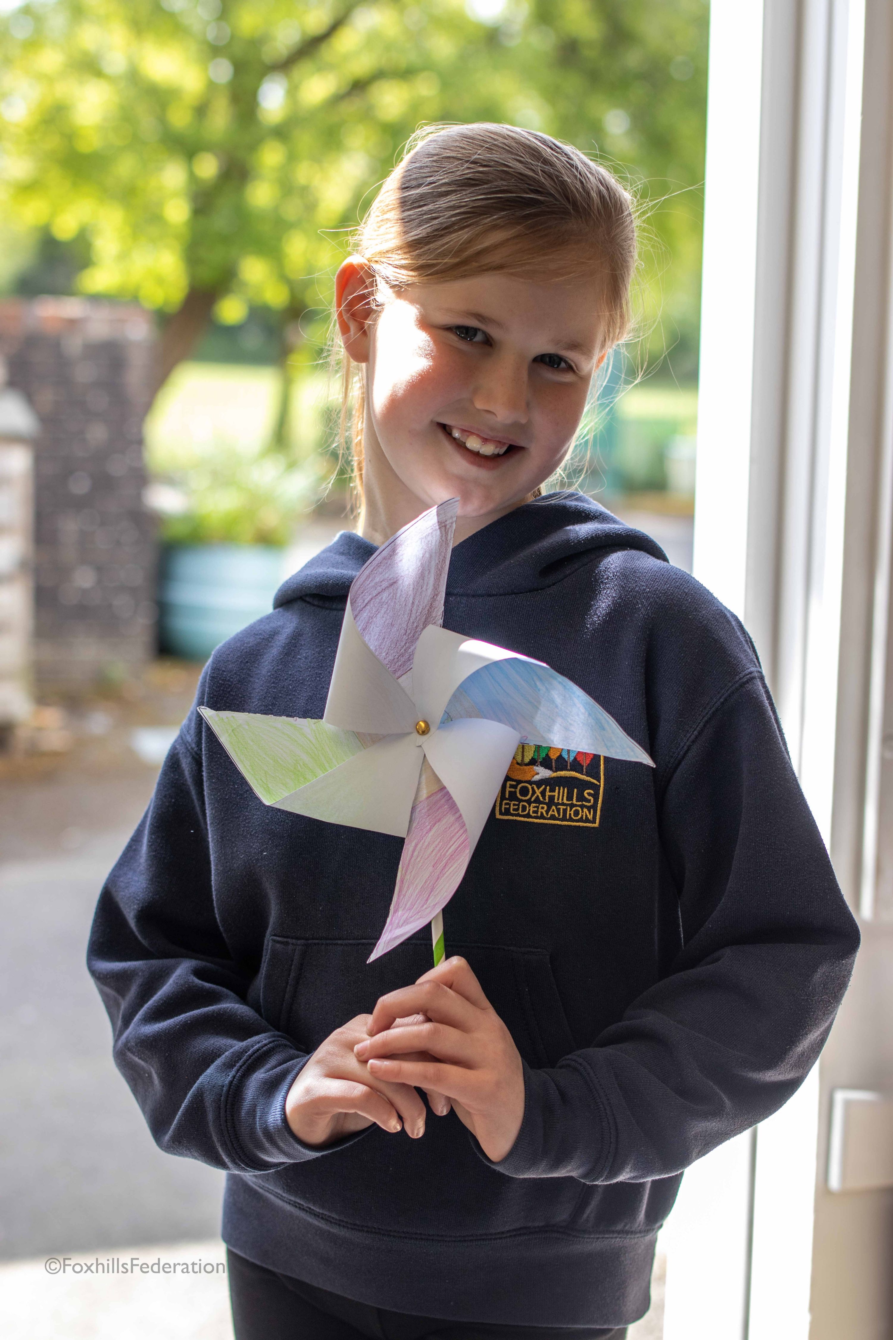 A girl holds a pinwheel