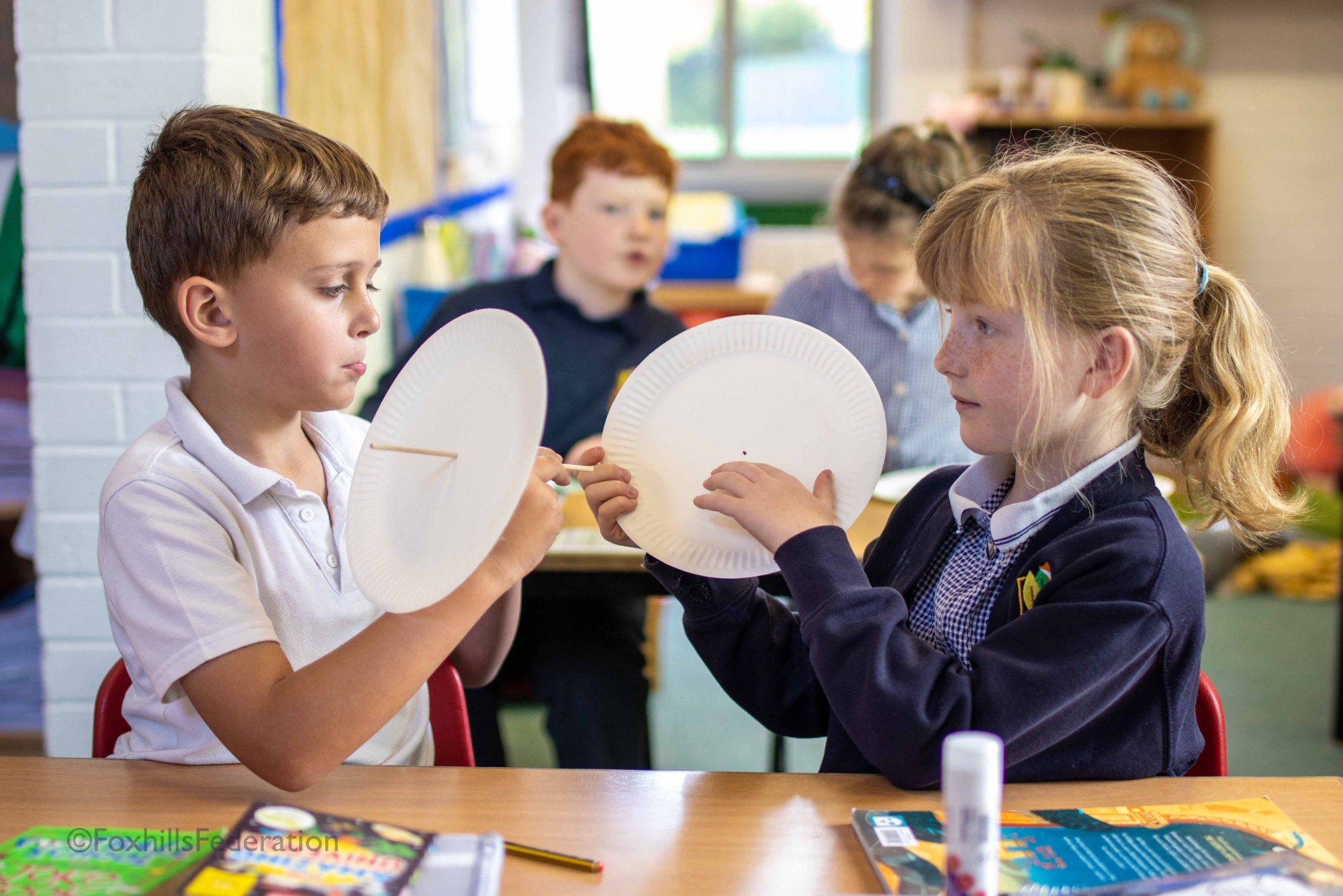 Two children make a water wheel