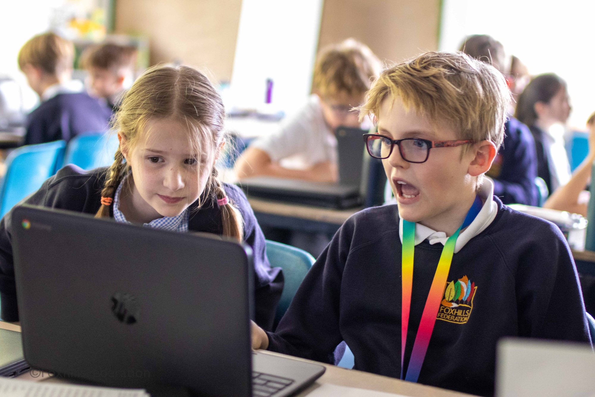 Two children look amazed at speadsheets
