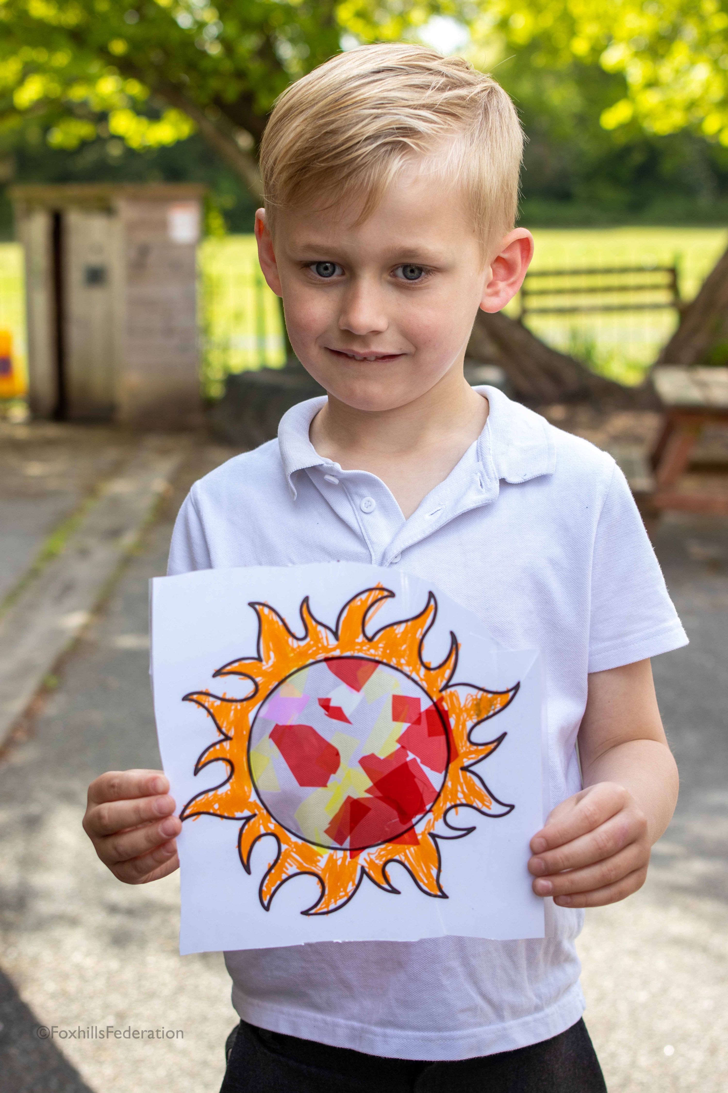 A boy holds his suncatcher