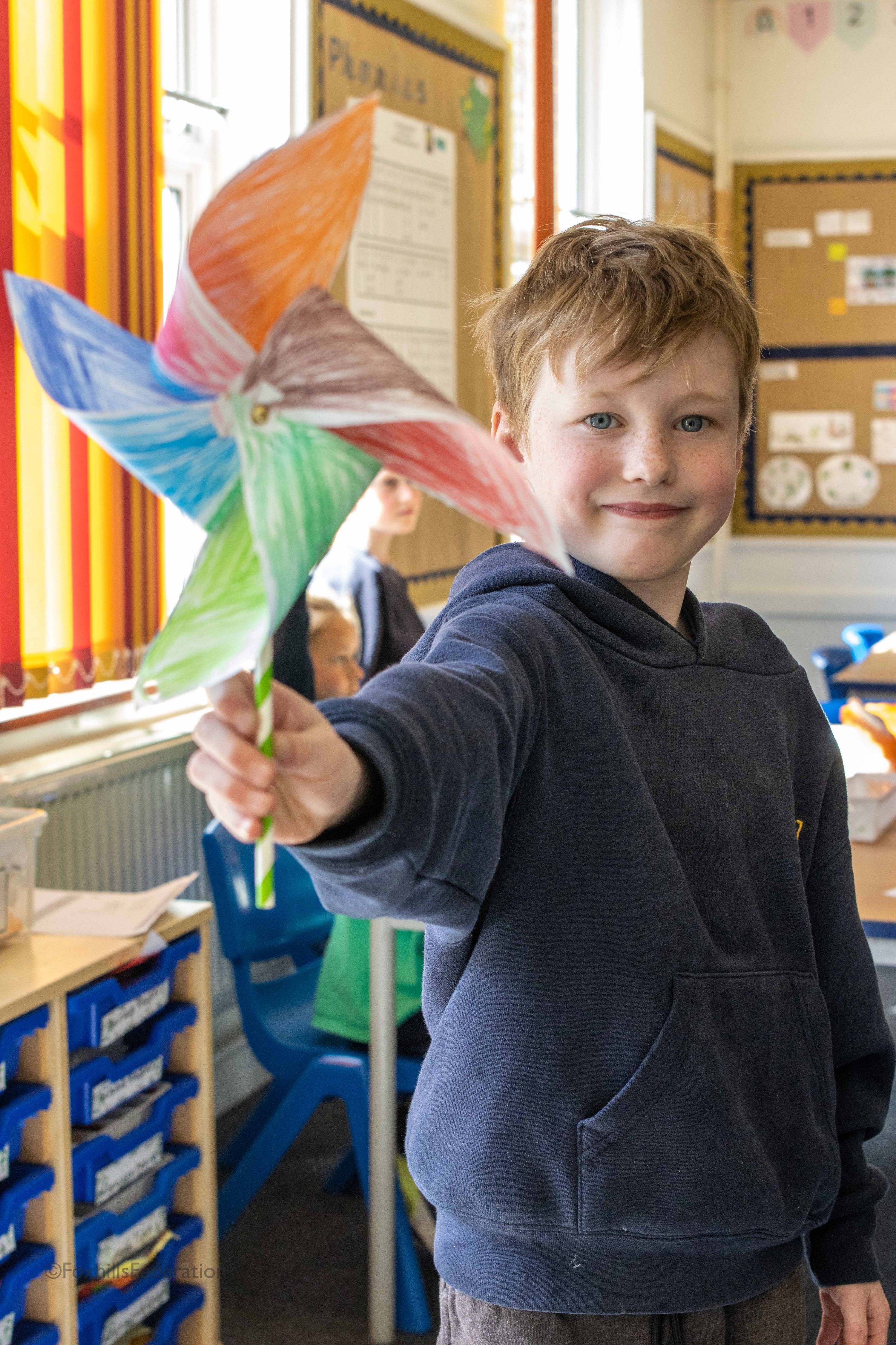 A boy holds a pinwheel