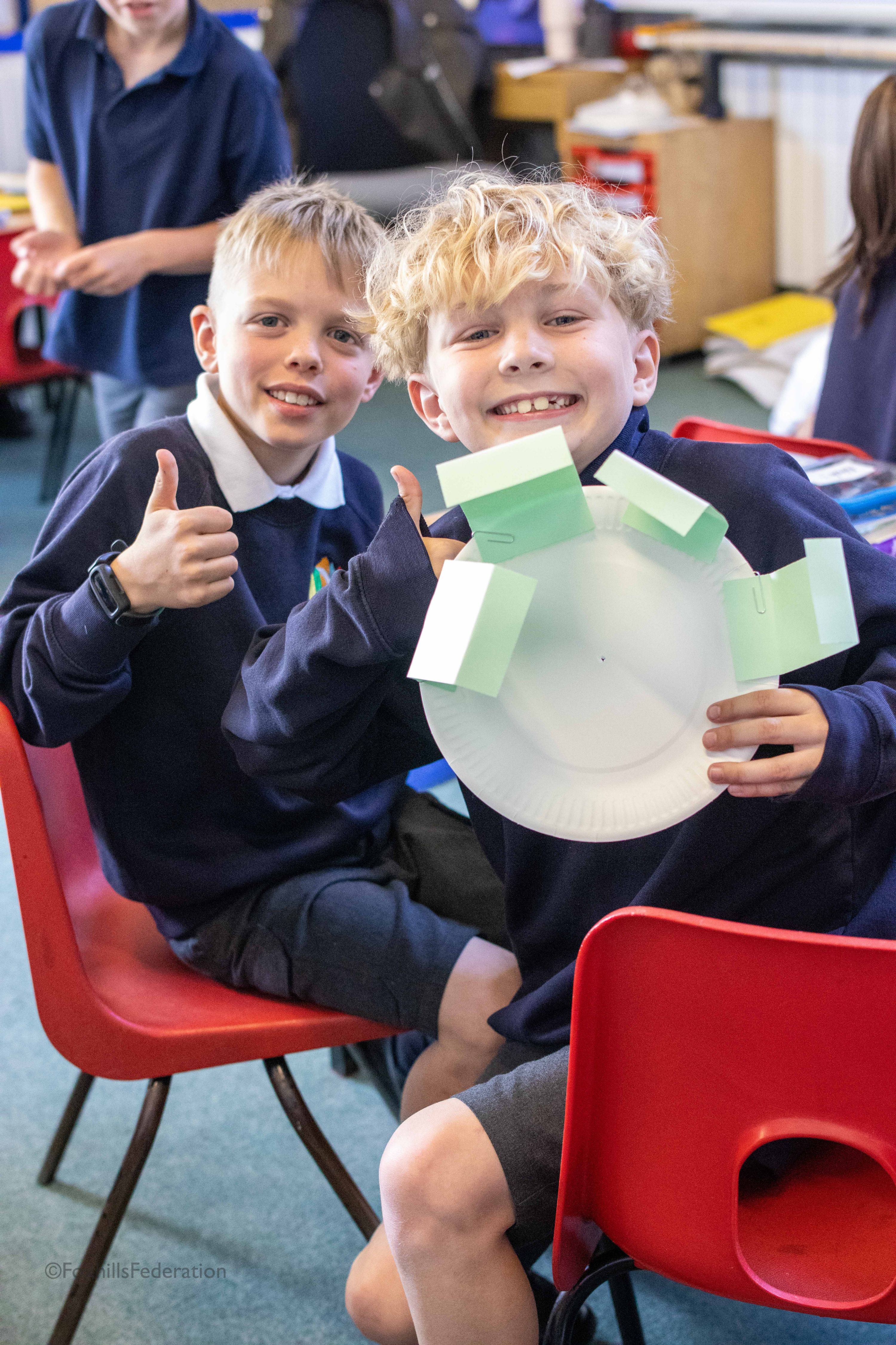 Two children make a water wheel