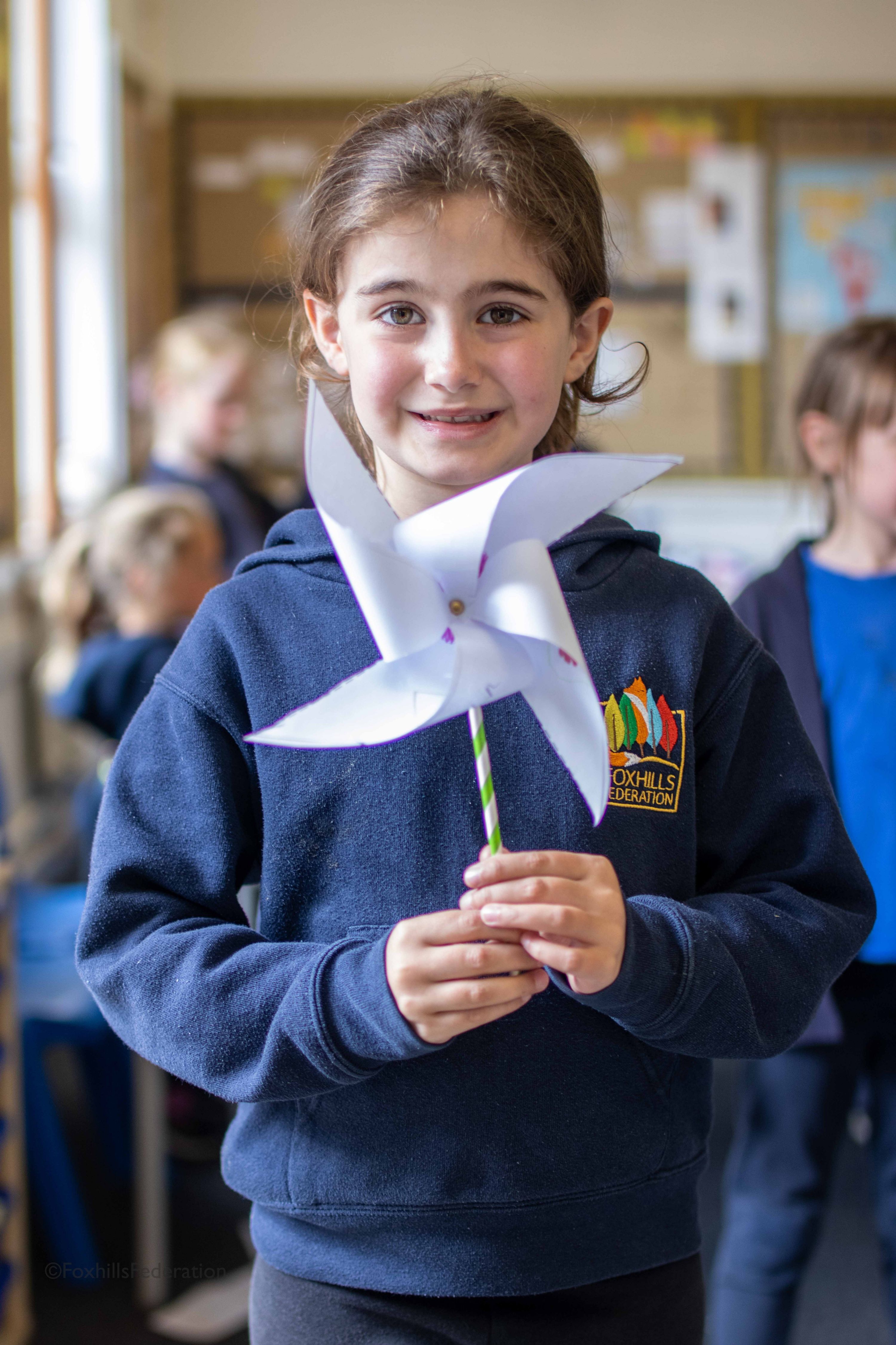 A girl holds a pinwheel