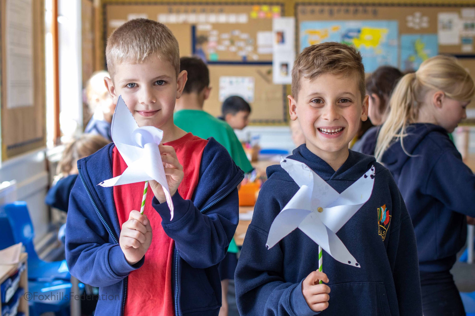 Two boys hold pinwheels