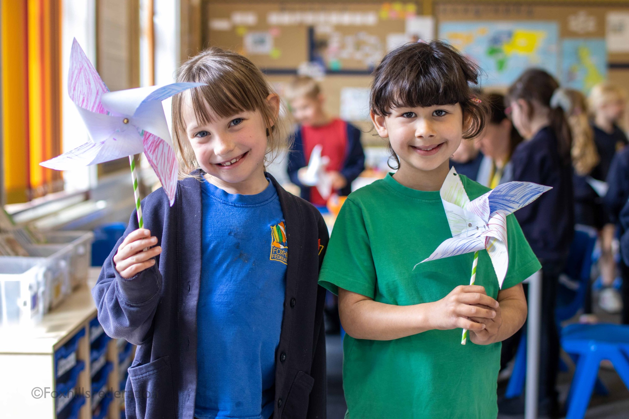 Two girls hold pinwheels