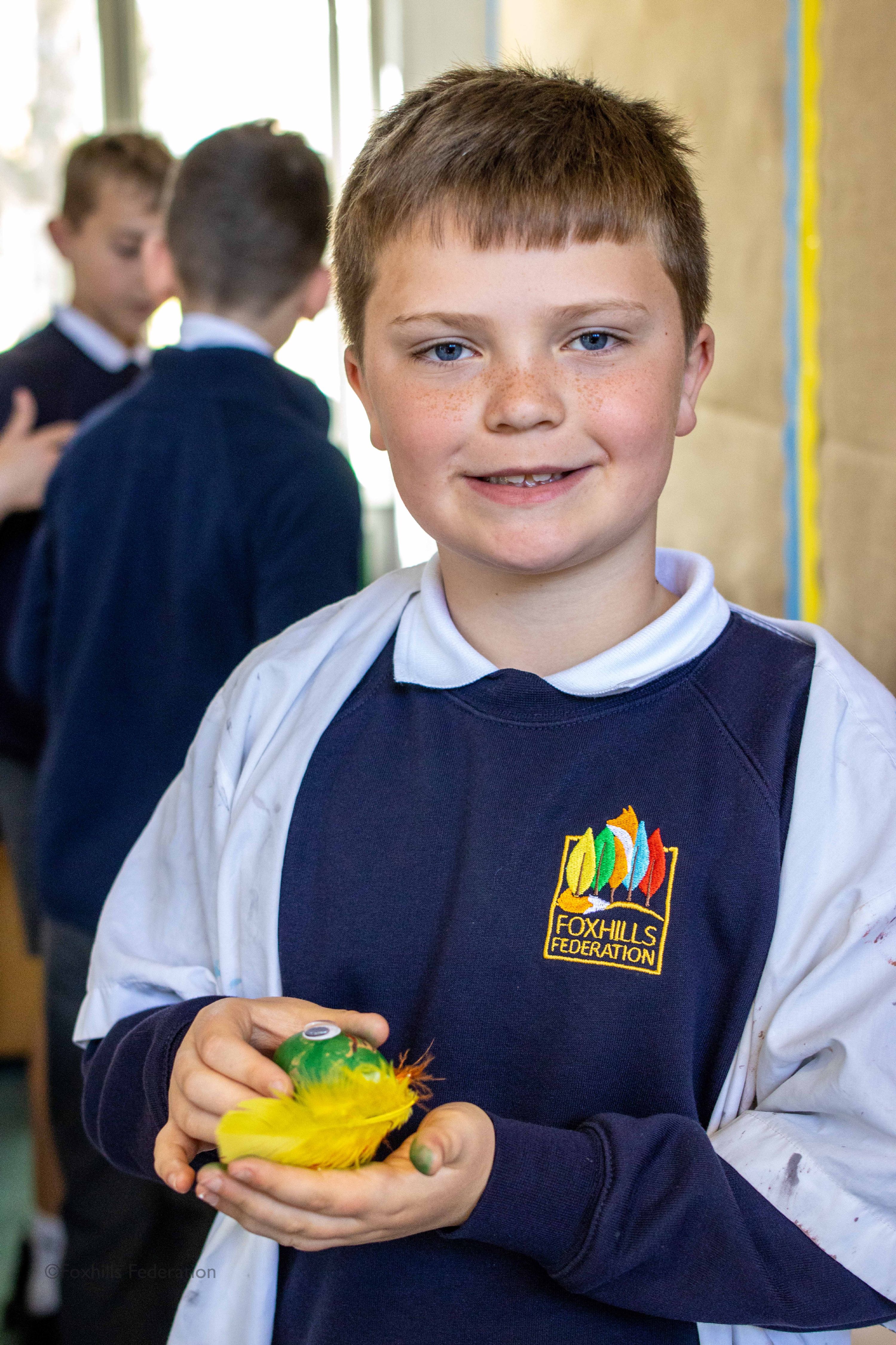 A boy holds a painted egg