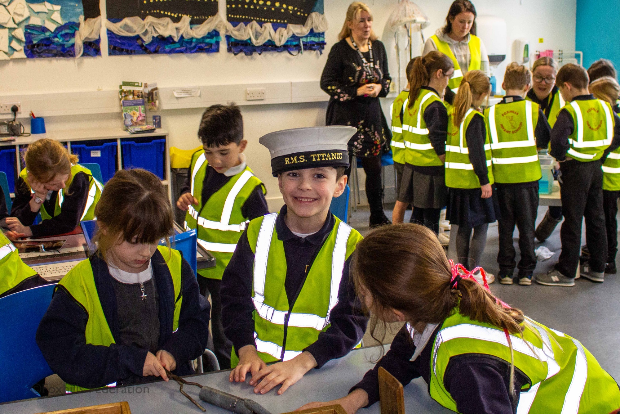 Children gather around objects from the SeaCity museum.