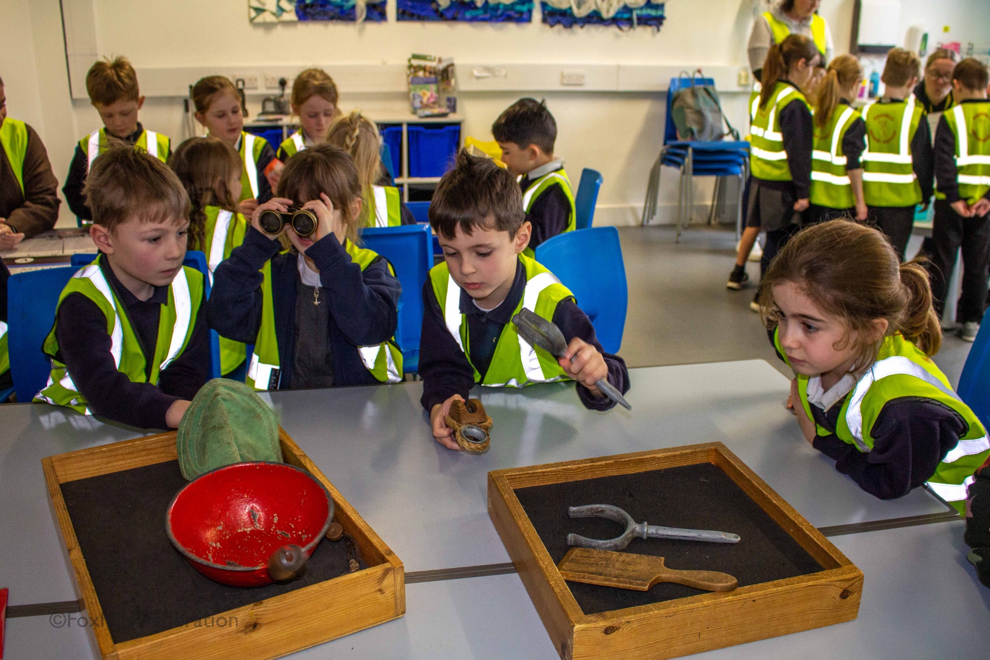 Children gather around objects from the SeaCity museum.