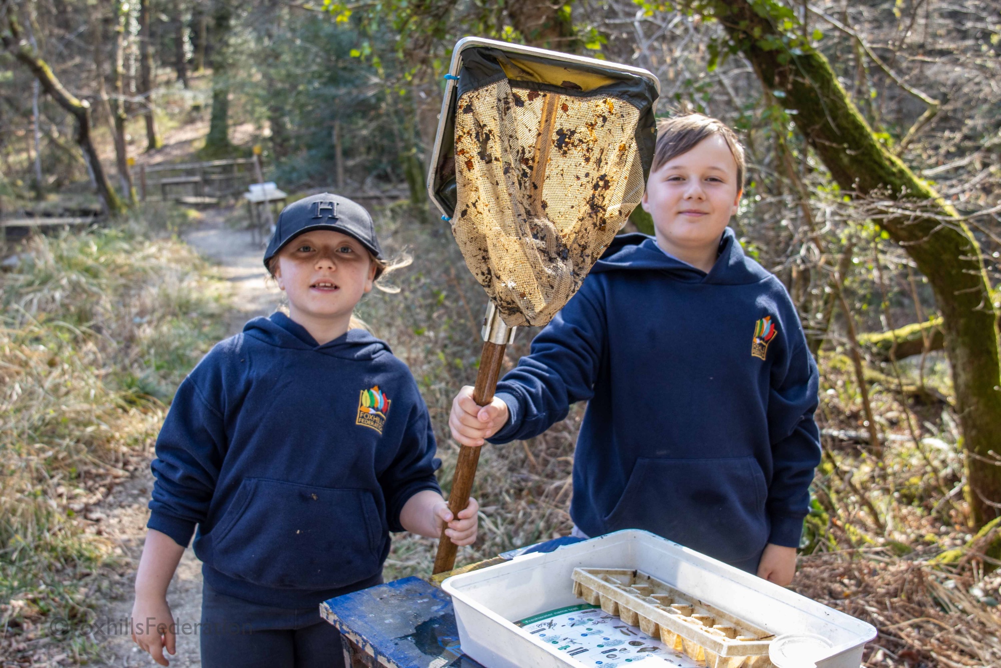 Two children hold a large net