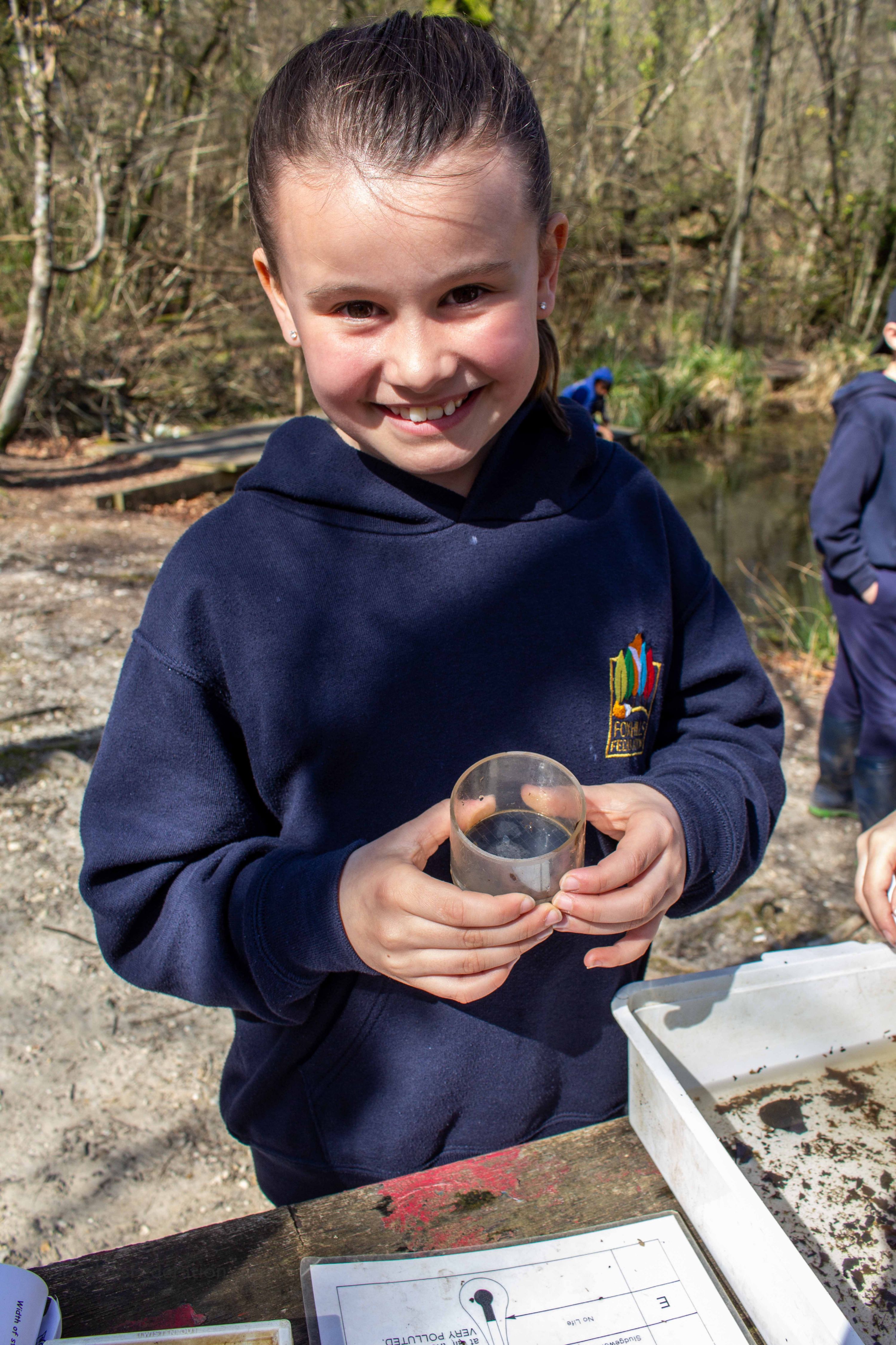 A girl holds one of her discoveries