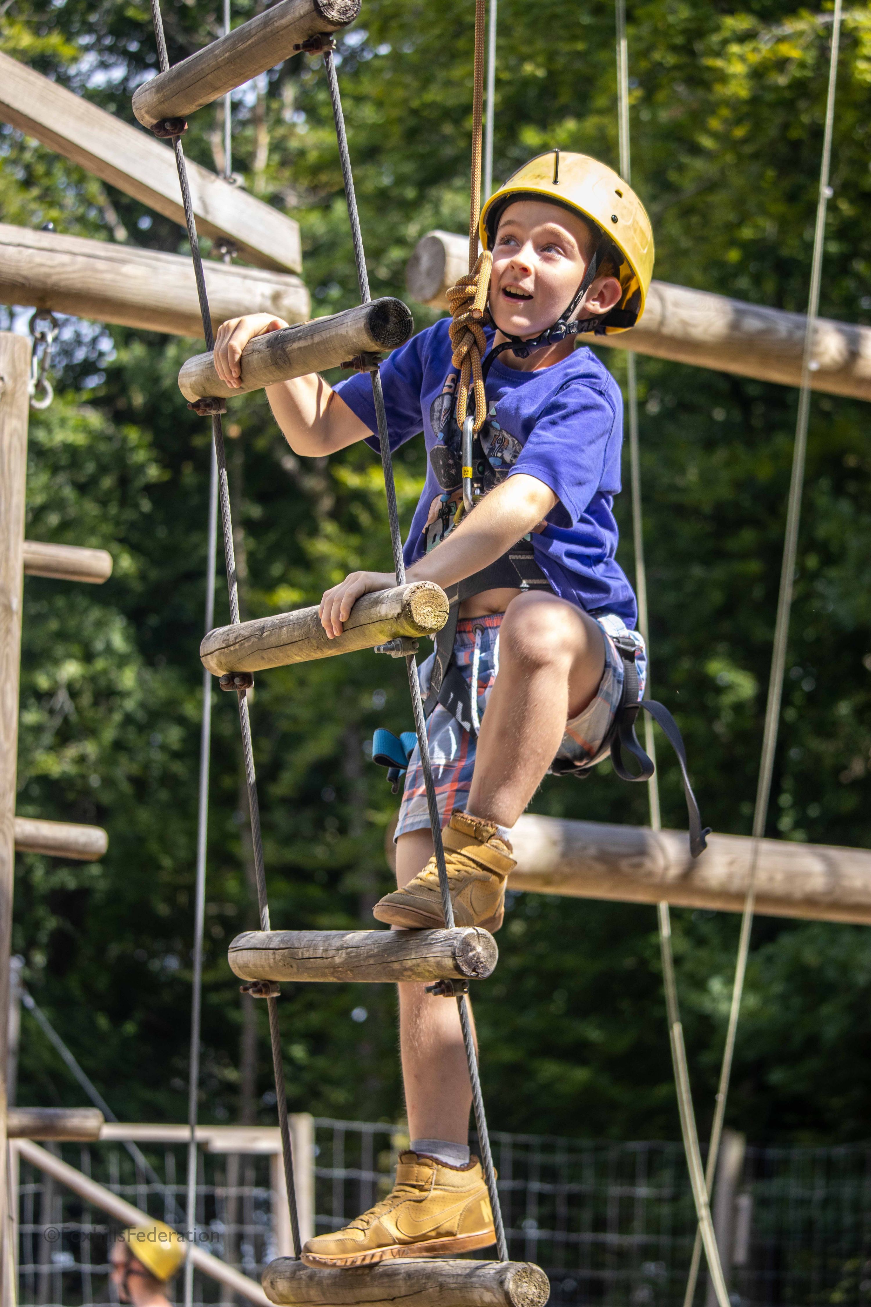 A boy climbs up a ladder