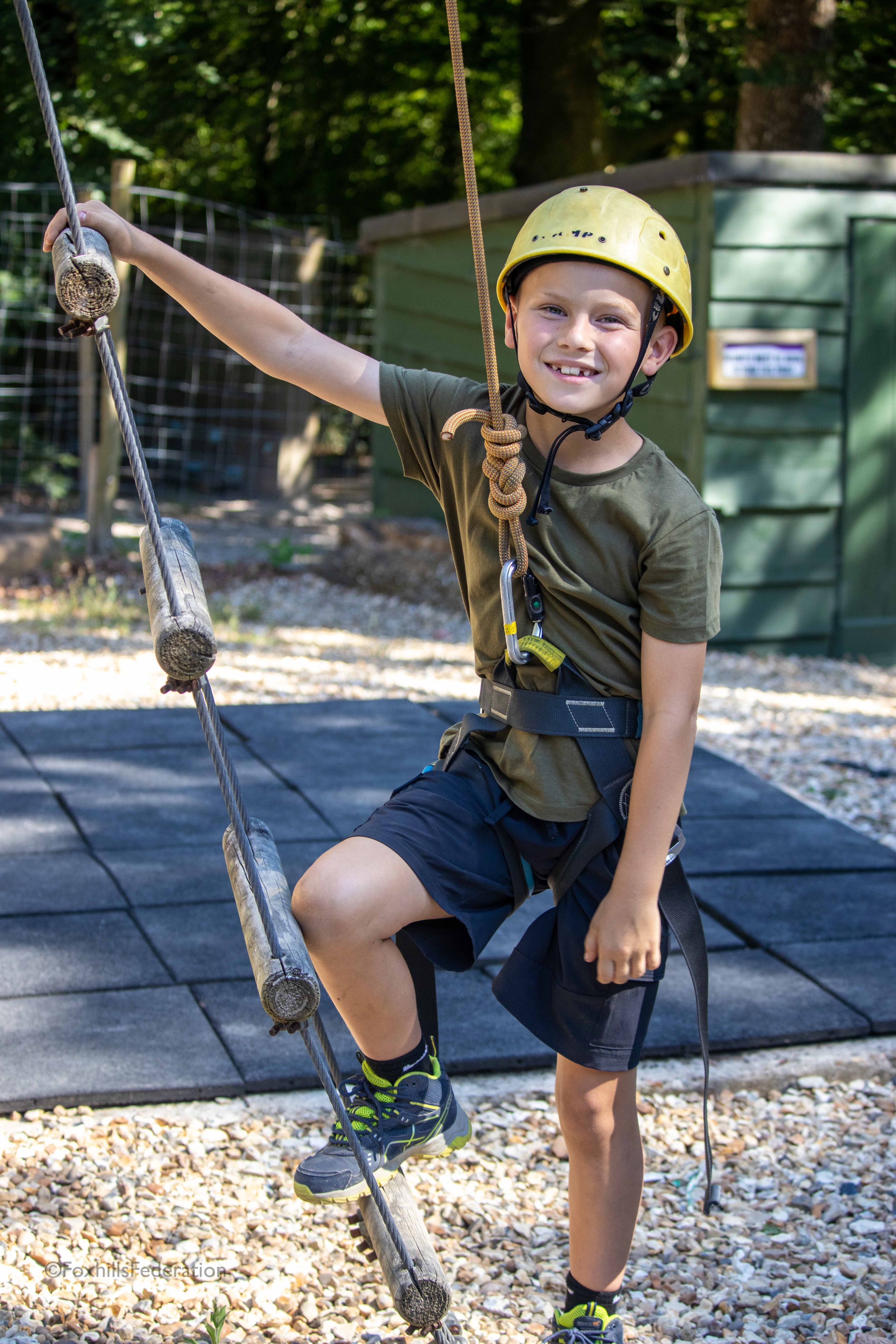 A boy poses by a ladder