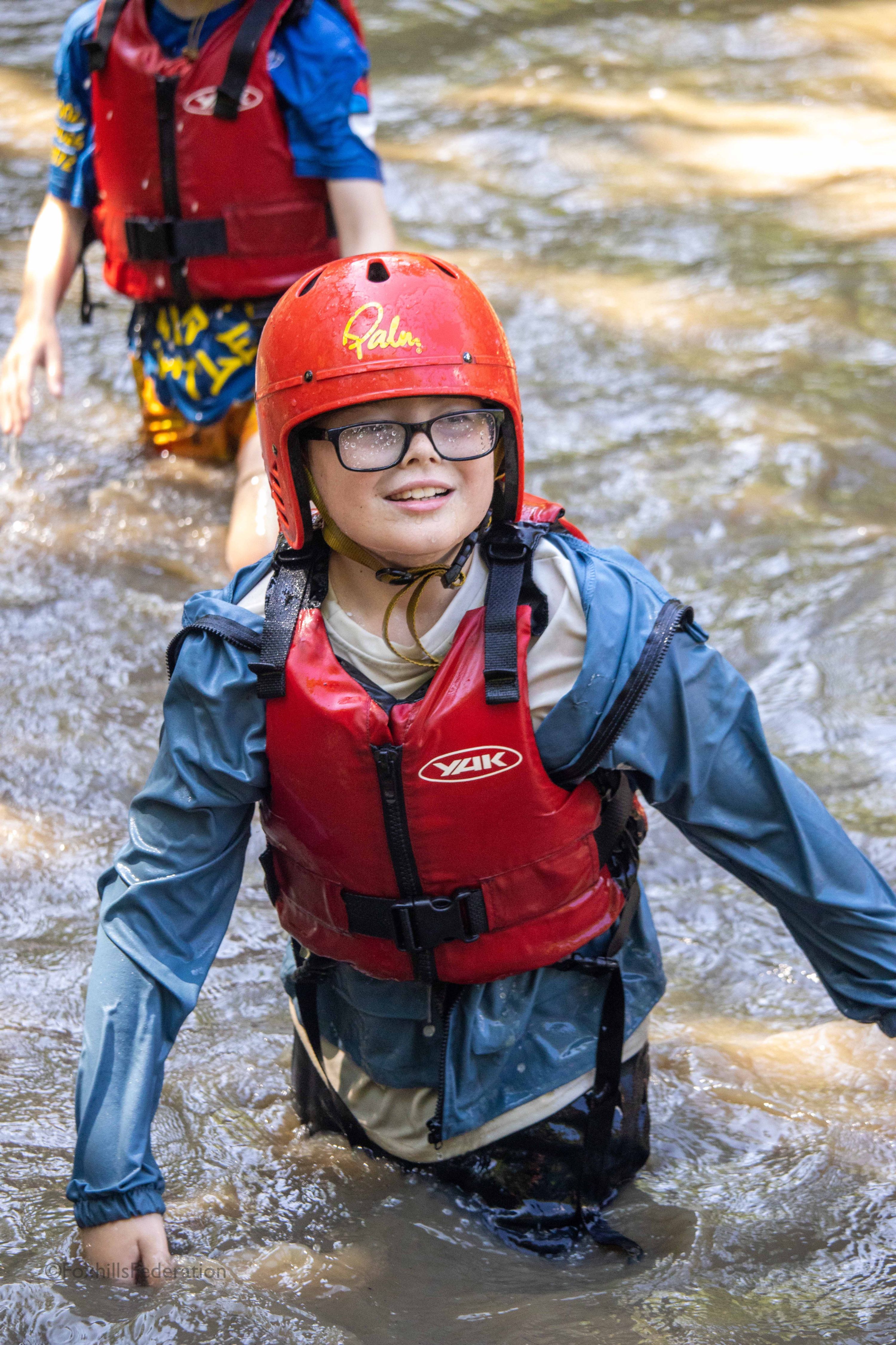 A child in water smiles