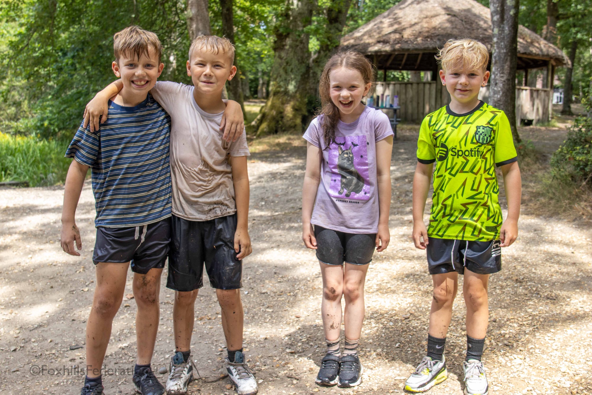 A group of wet children smile