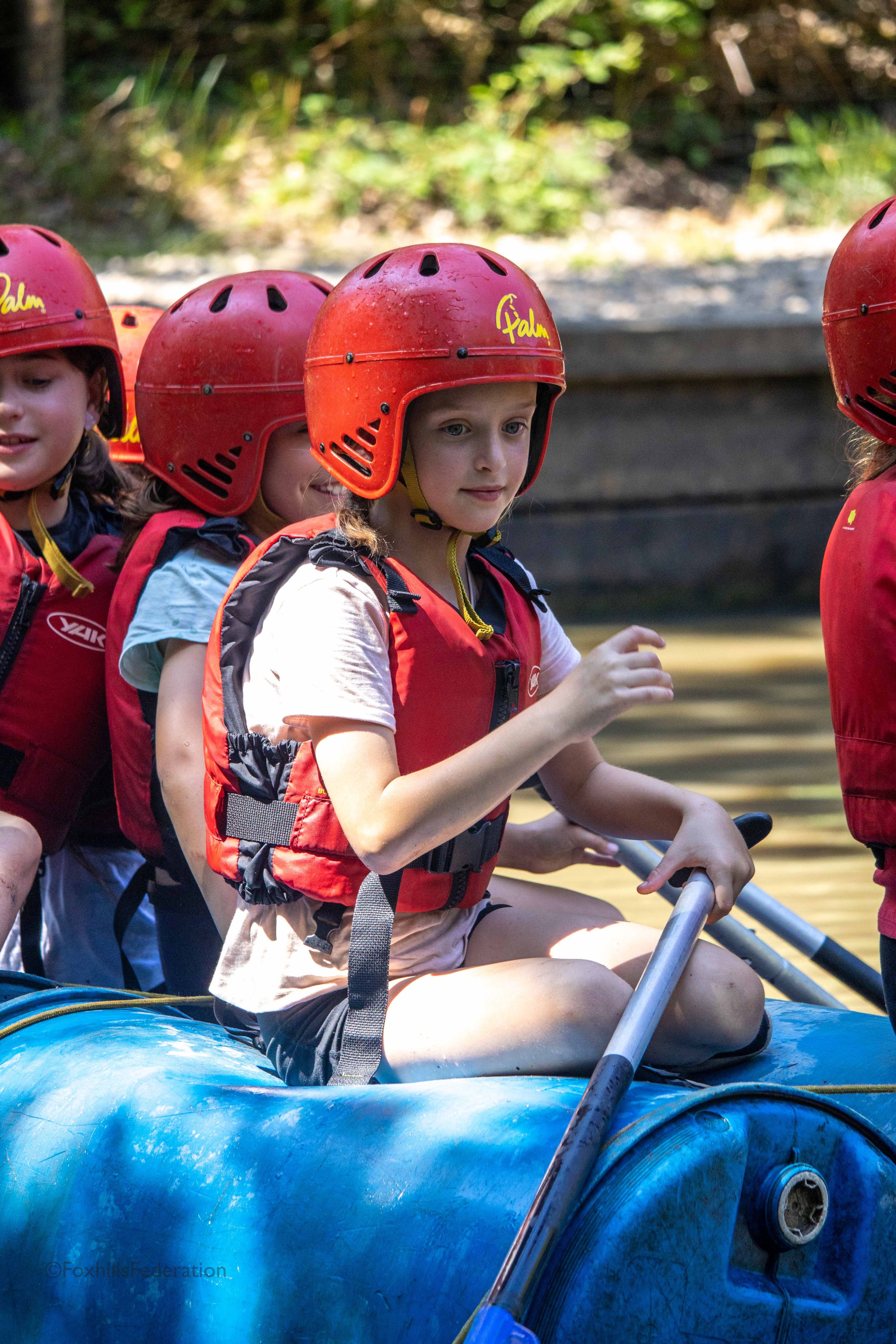A girl pilots a raft