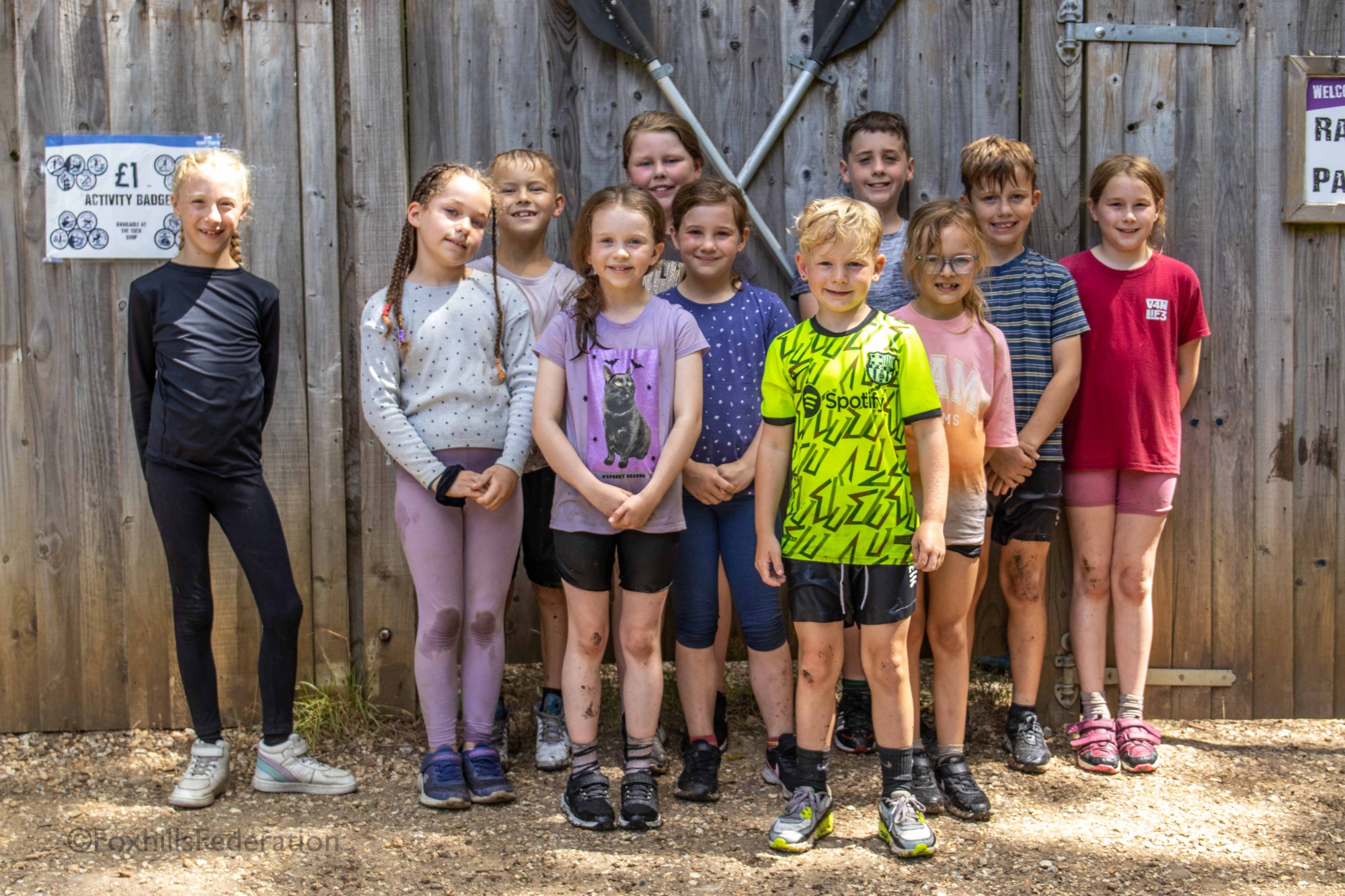 A group of children stand dripping after raft building