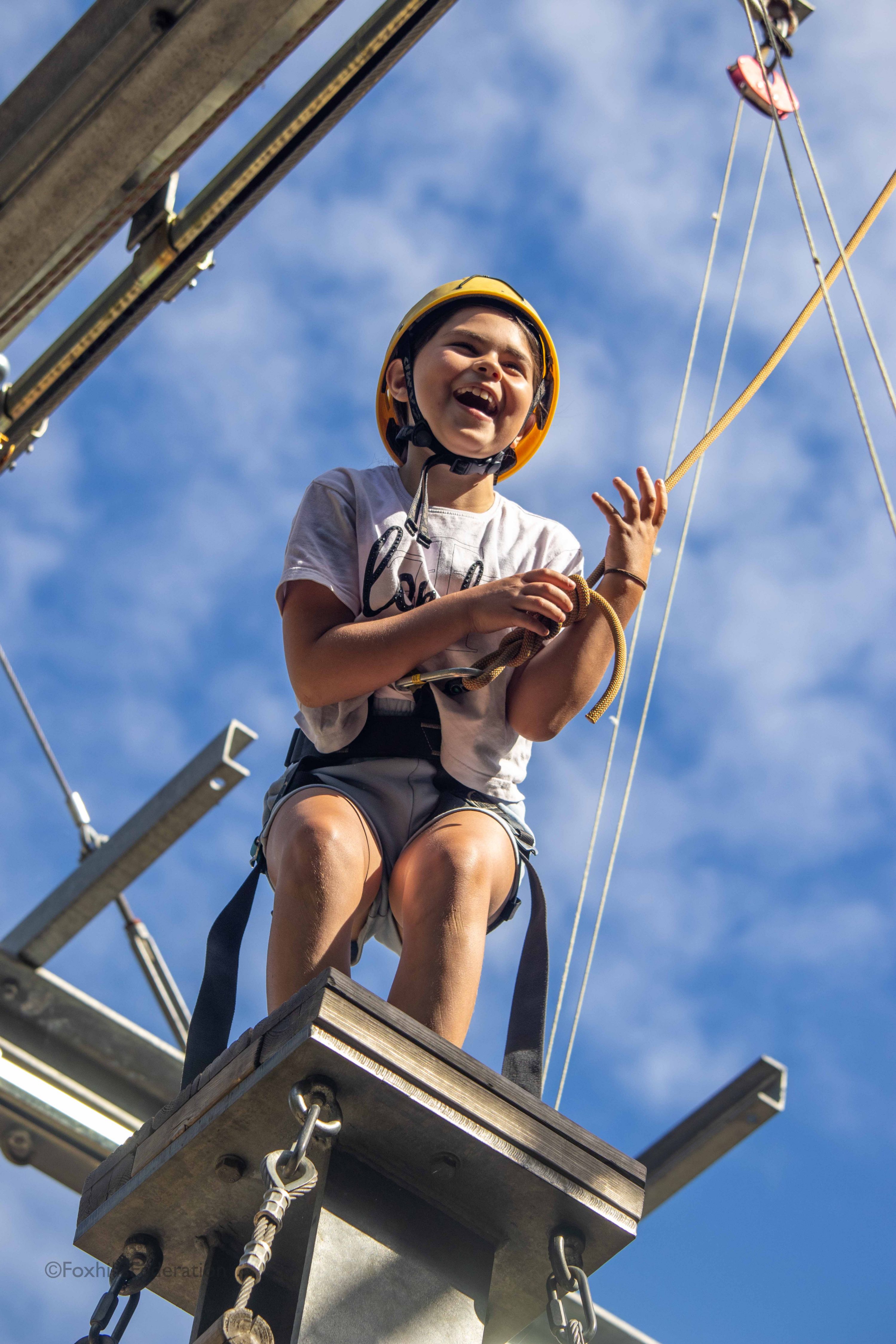A girl stands at the top of a high tower