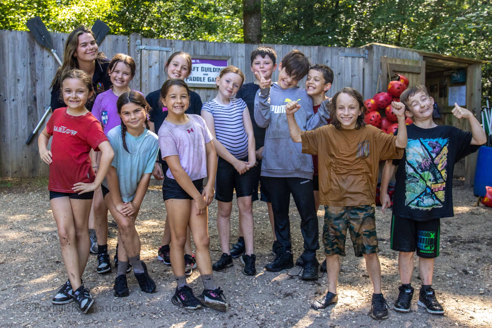 Children pose after completing raft building