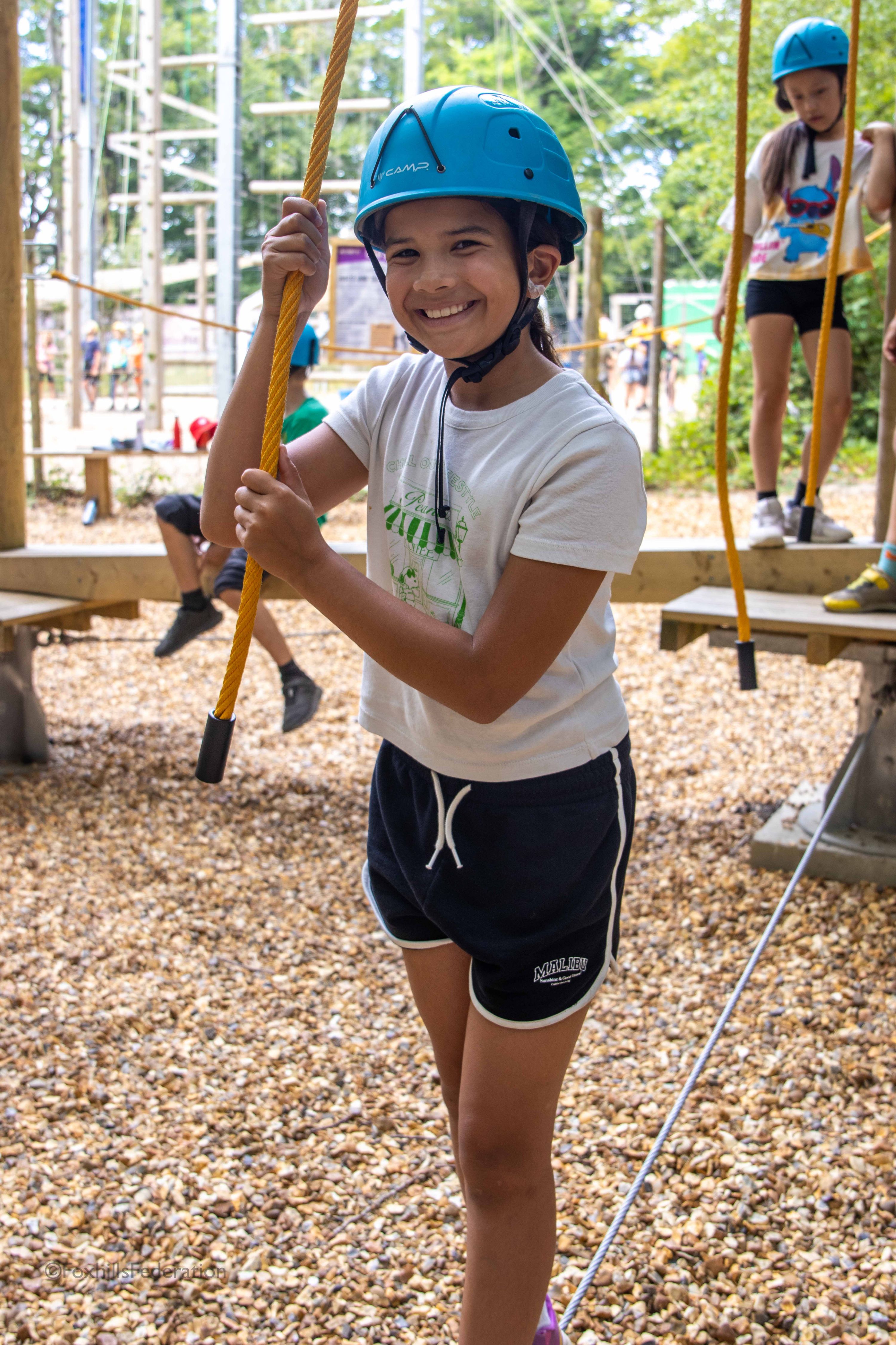 A girl poses with a low rope