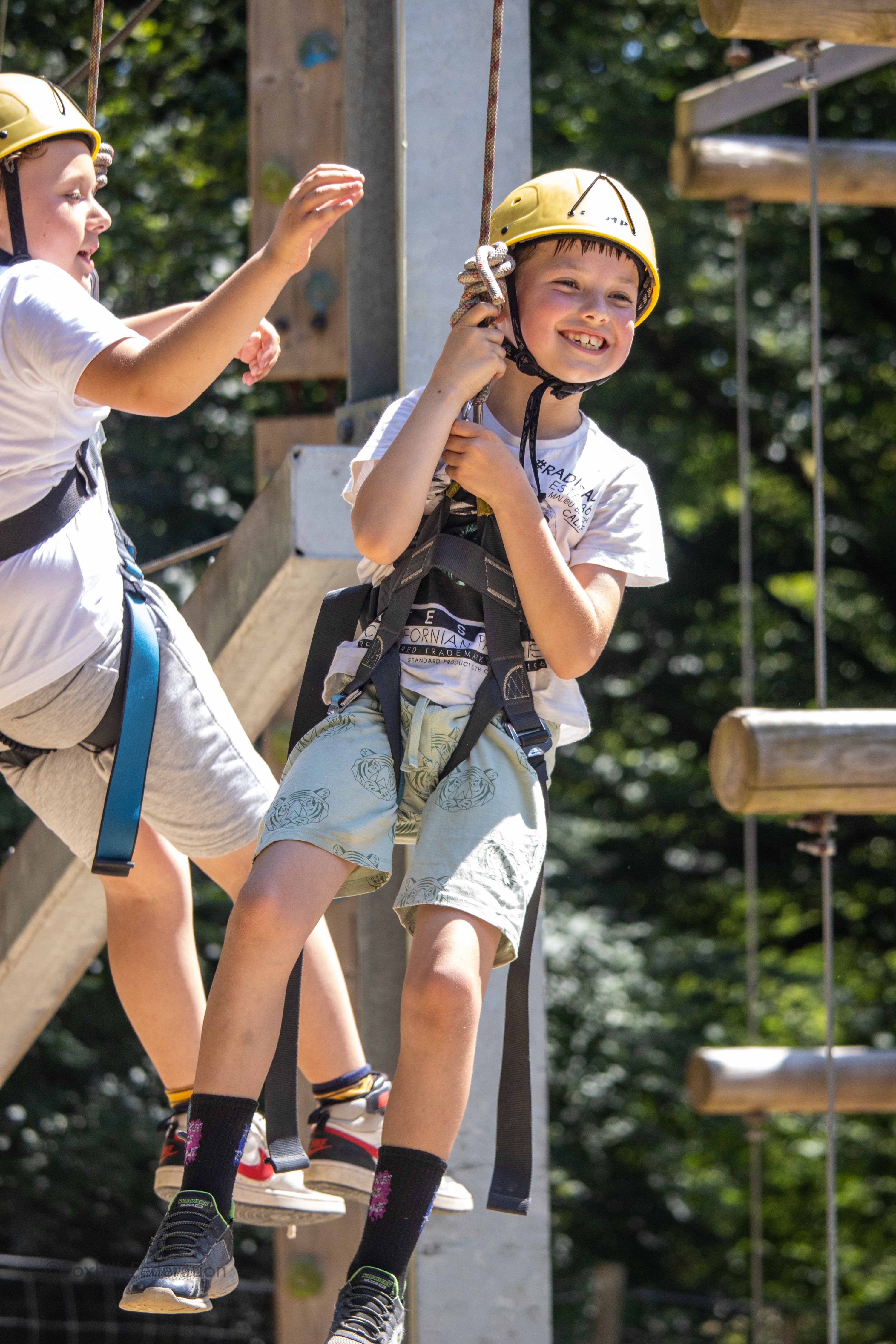 A boy hangs in the air after crate stacking
