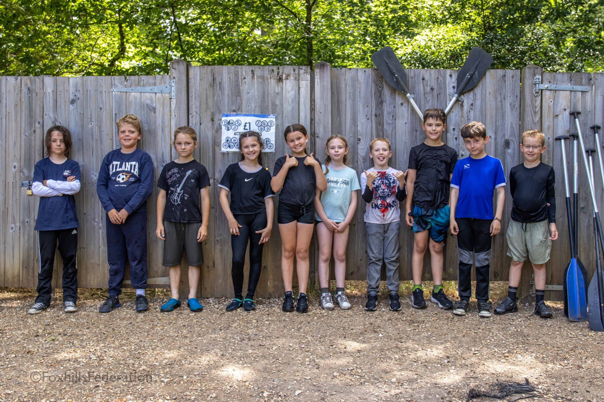 A group of children pose after raft building
