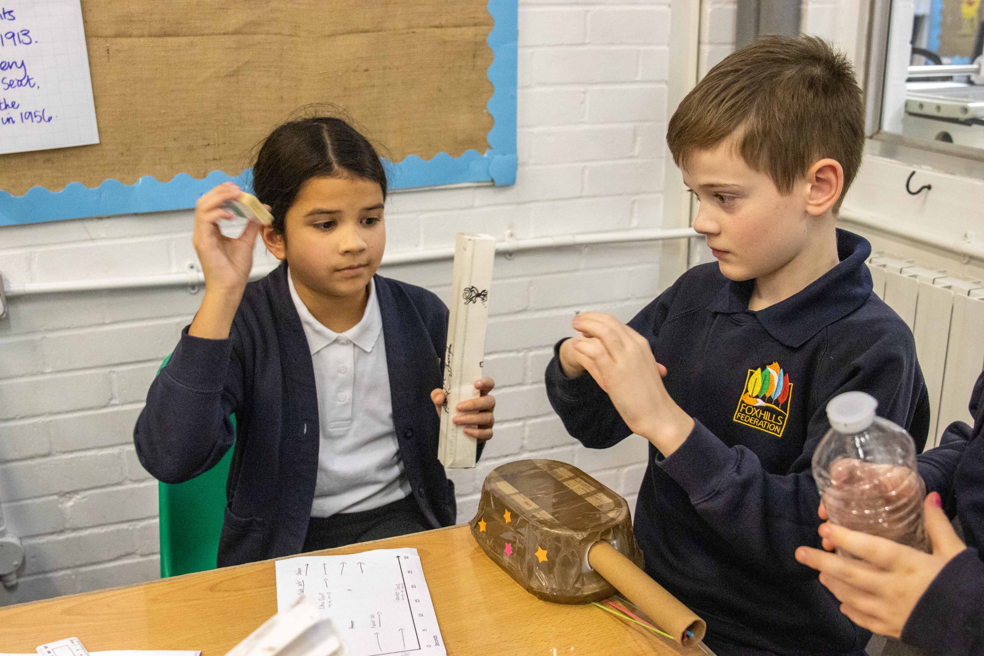 Children play homemade music instruments.