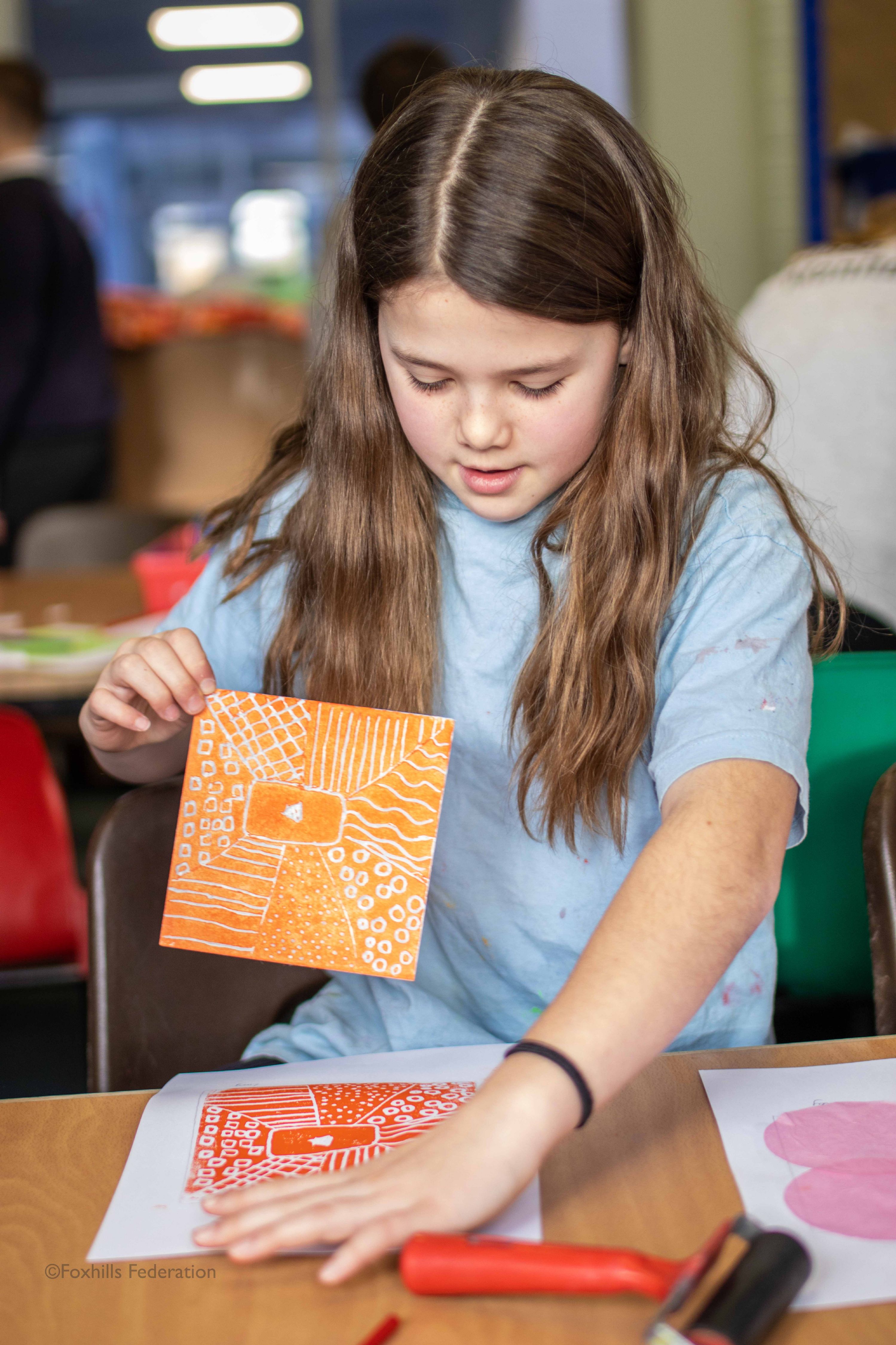 A girl creates work with stamp printing.