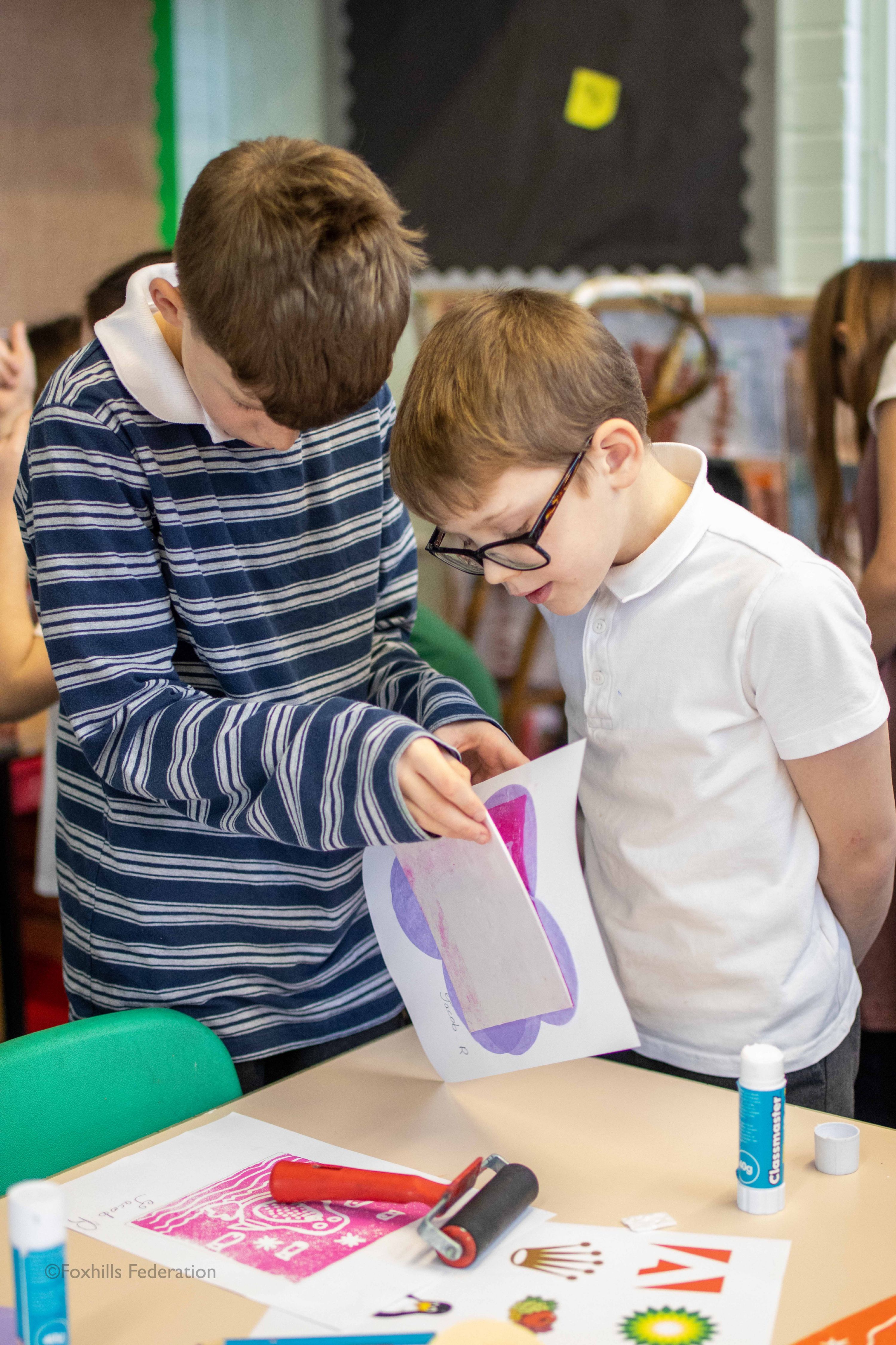 A boy creates work with stamp printing.