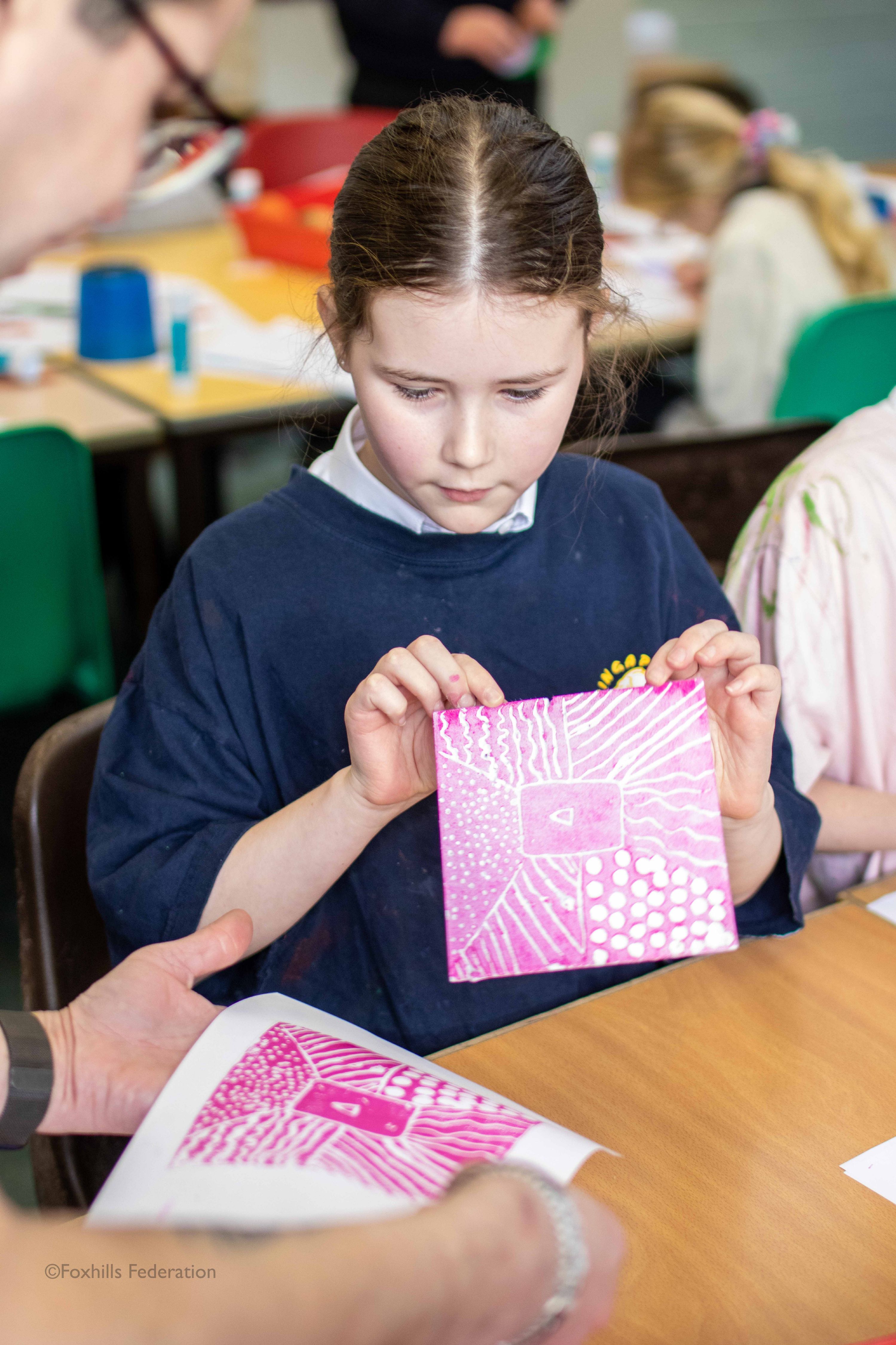 A girl creates work with stamp printing.