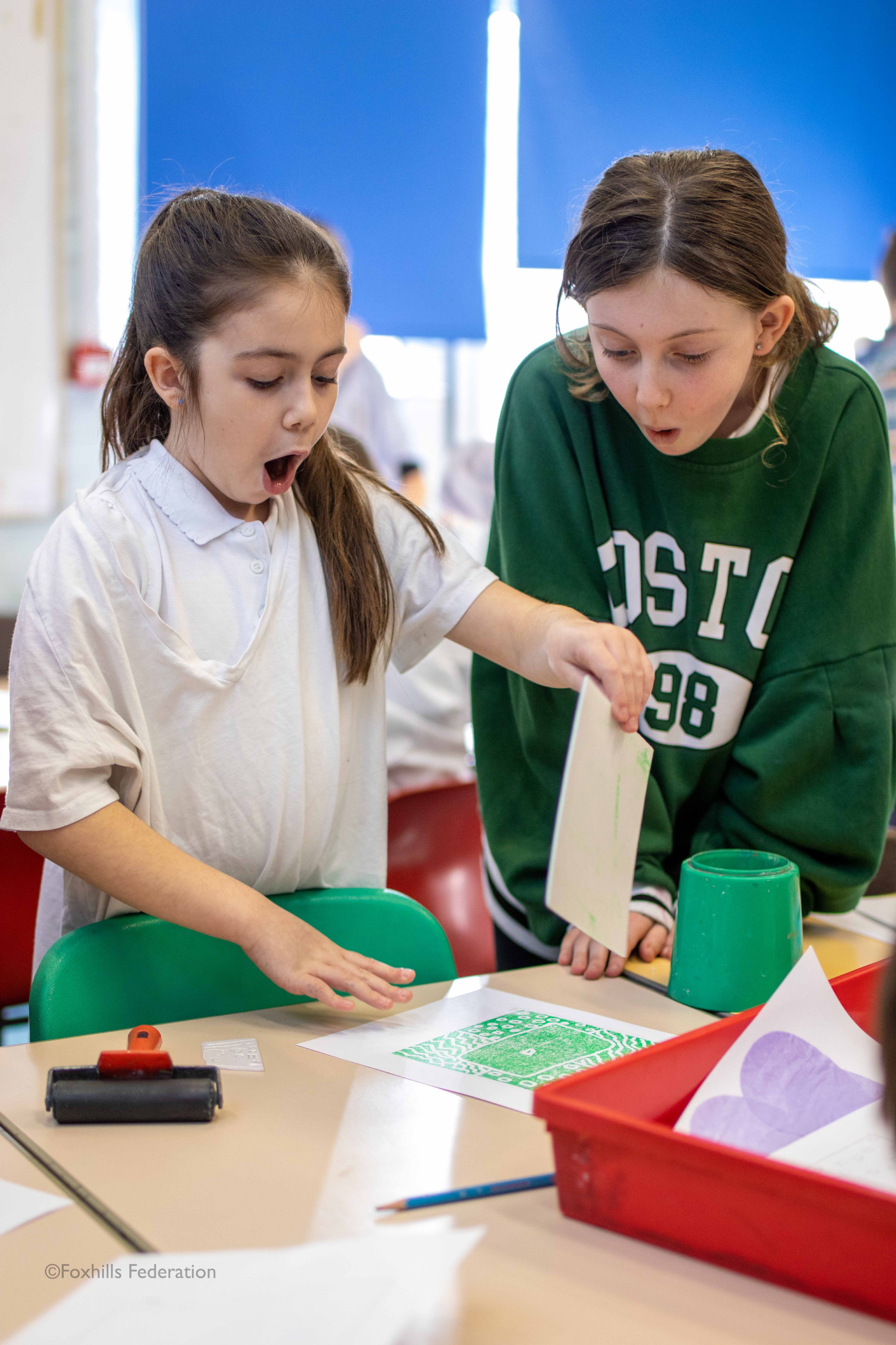 A girl creates work with stamp printing.