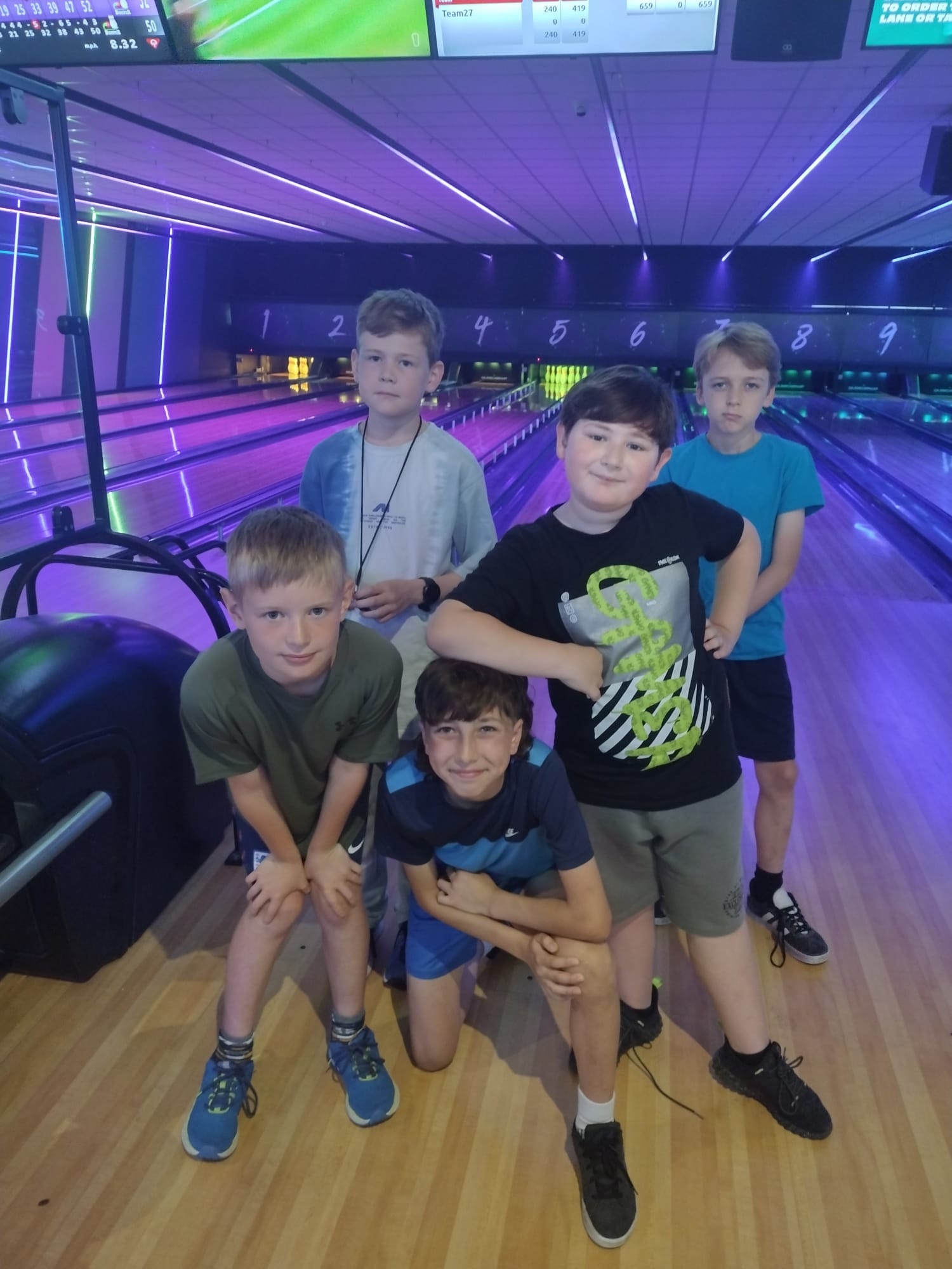 Boys enjoy a game of bowling
