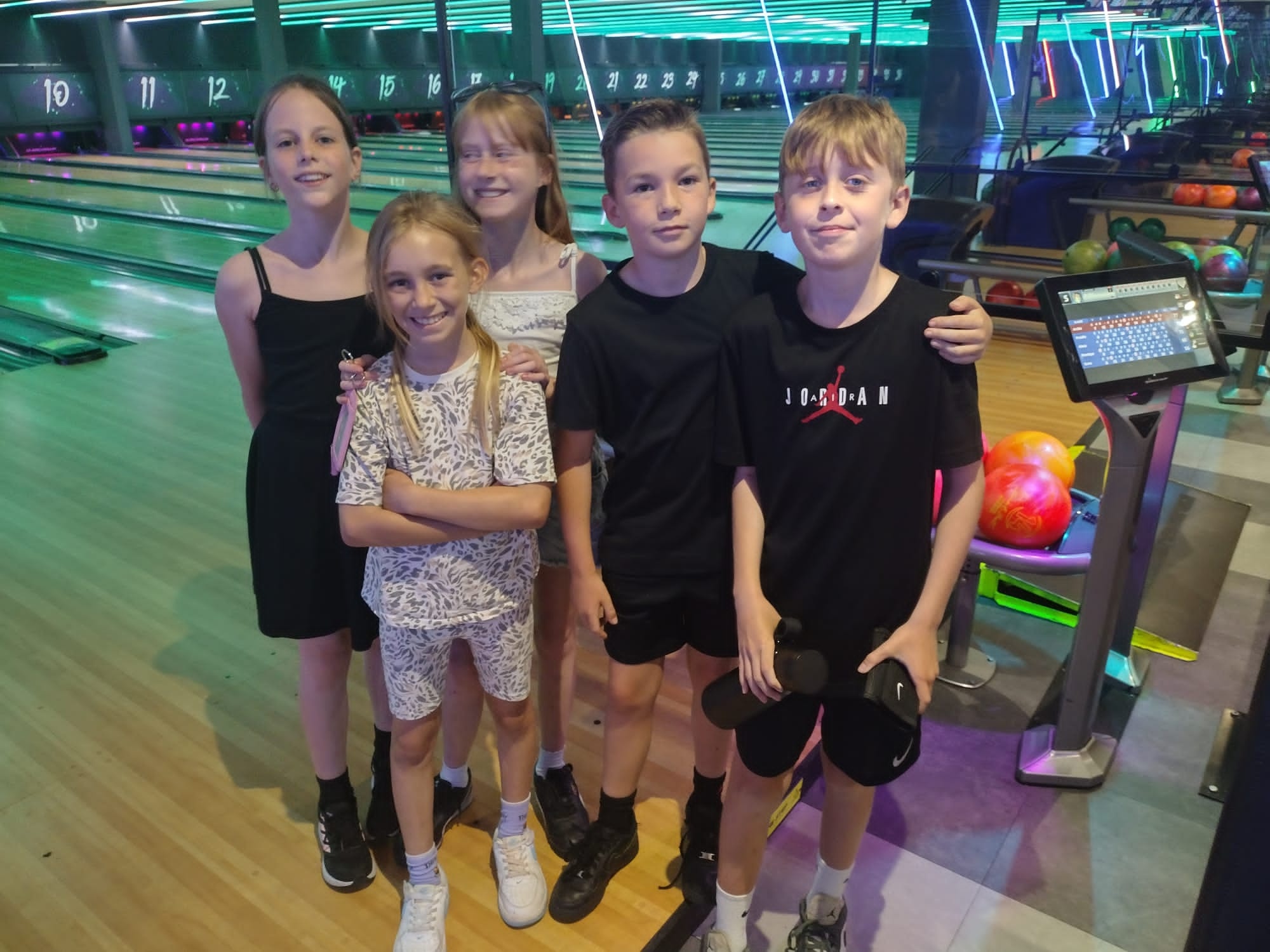 Children enjoy a game of bowling