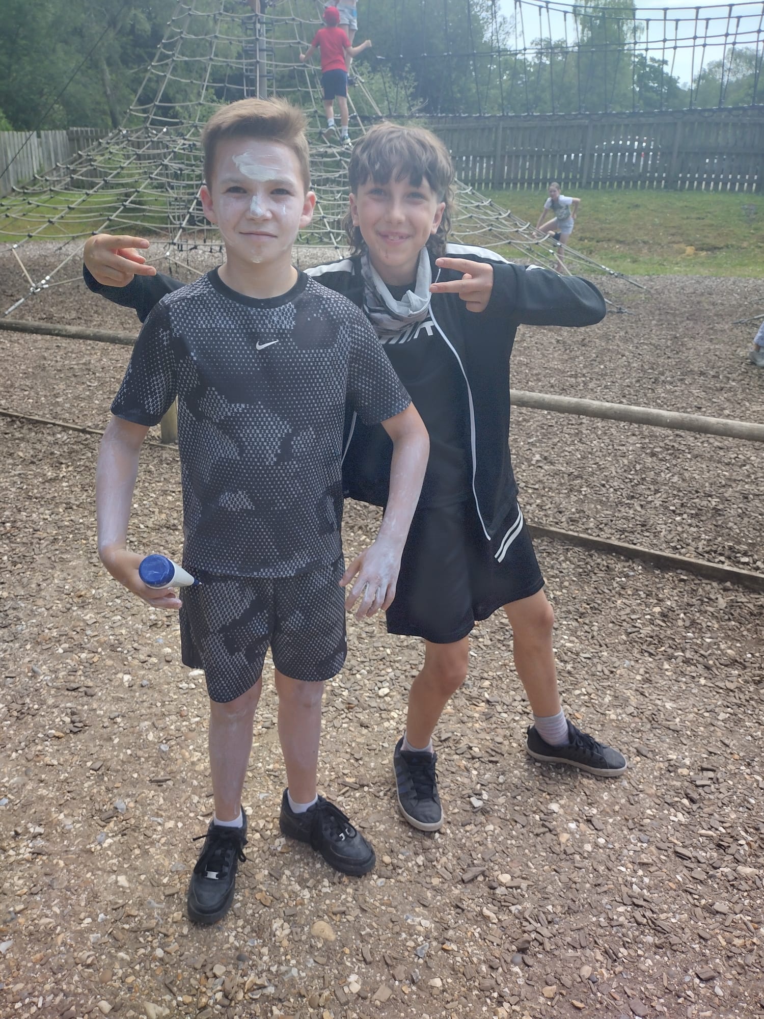 Boys pose while covered in sun cream
