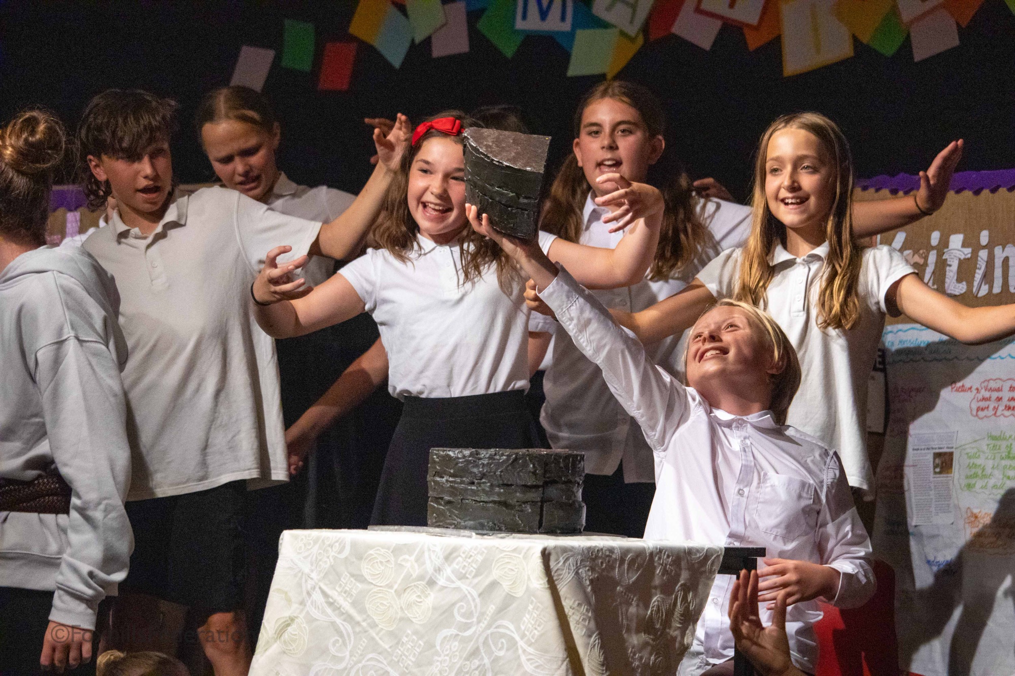 Bruce Bogtrotter holds a slice of cake triumphally