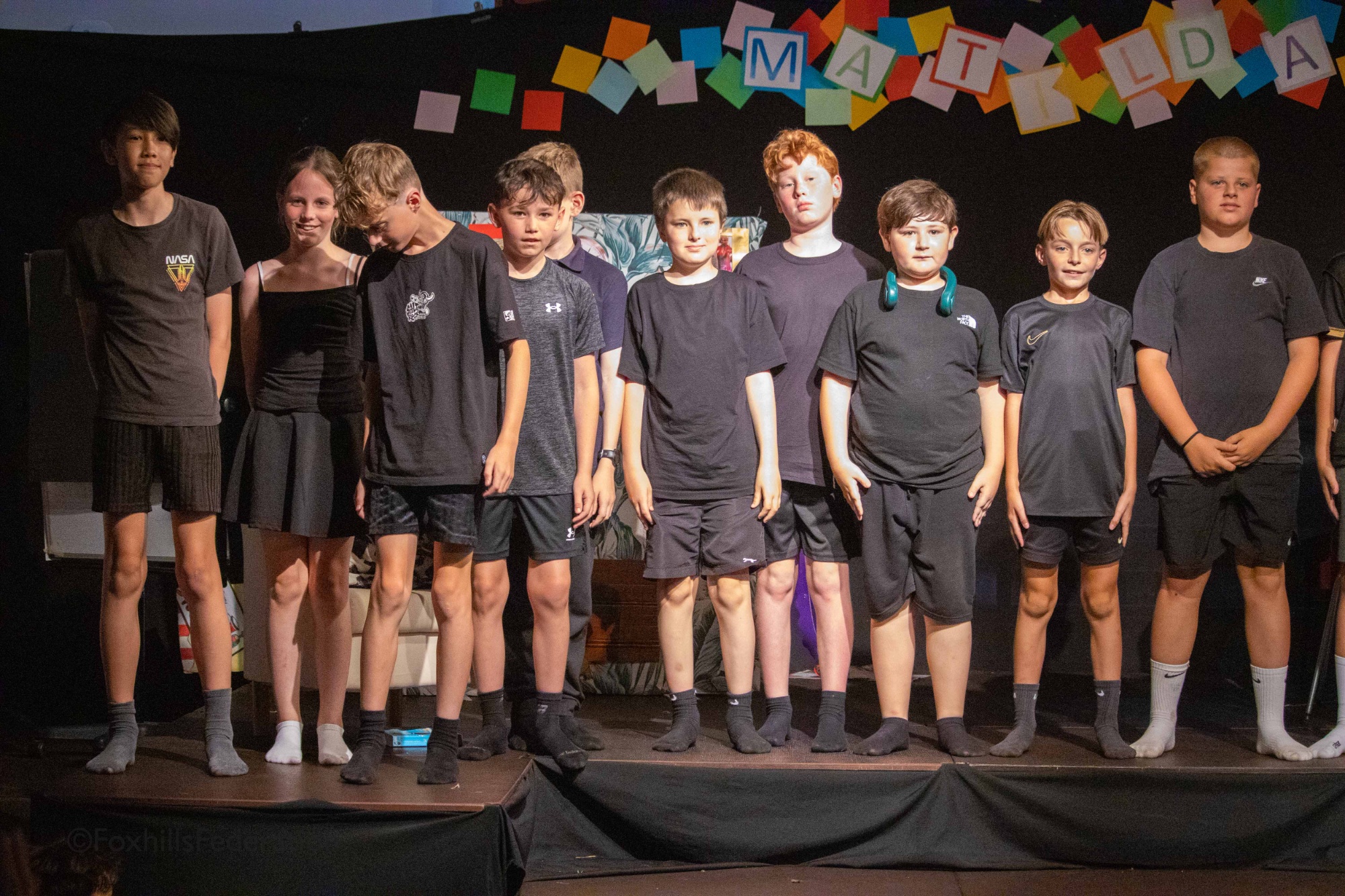 The stage crew stand to bow