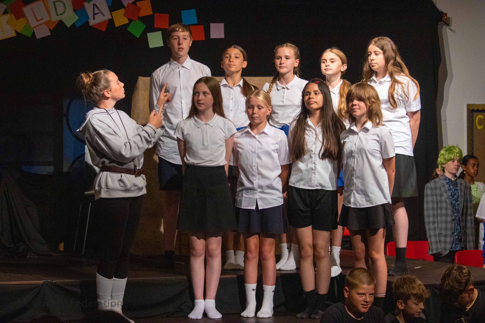 Miss Trunchbull conducts a choir of children