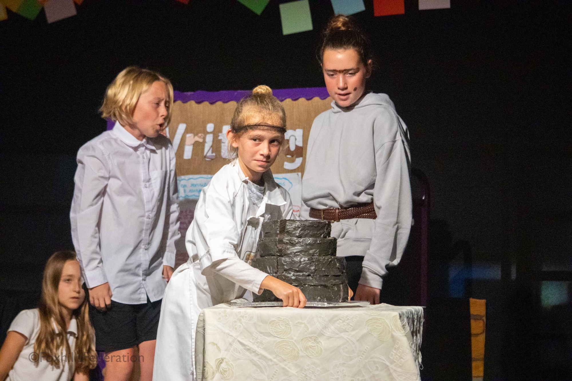 The school cook brings out a new cake