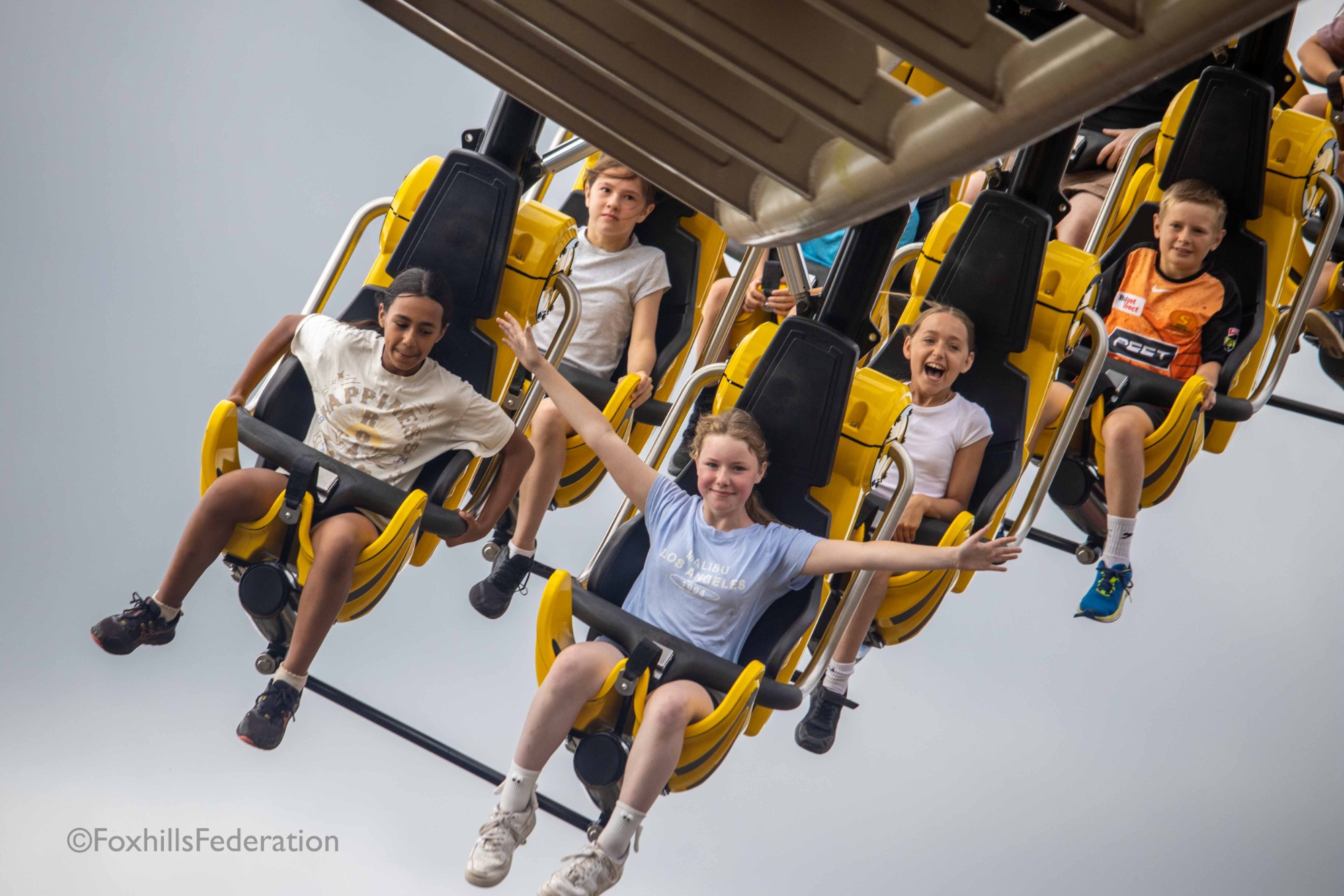 Children fly through the air on a rollercoaster