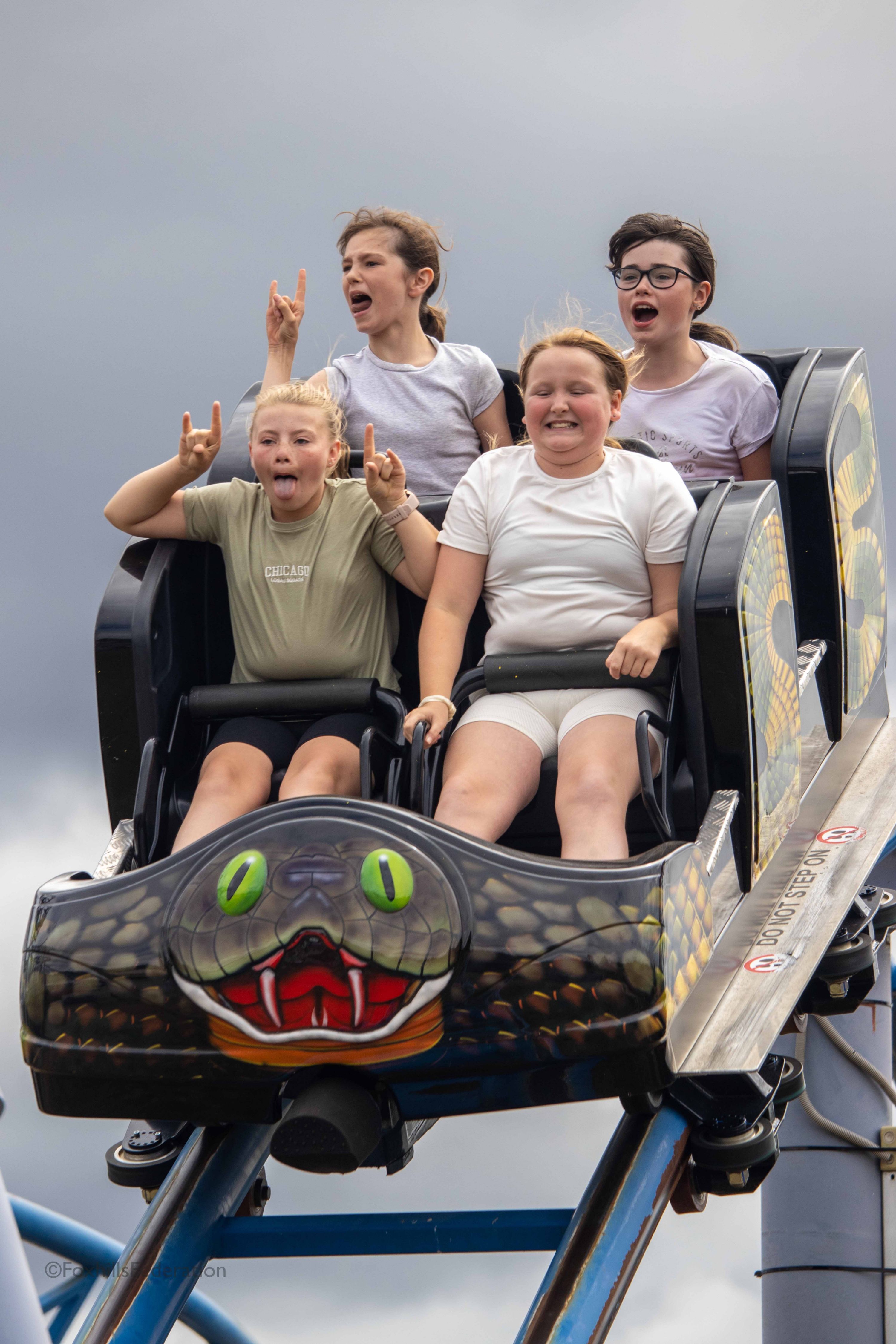 A group of children scream on a rollercoaster