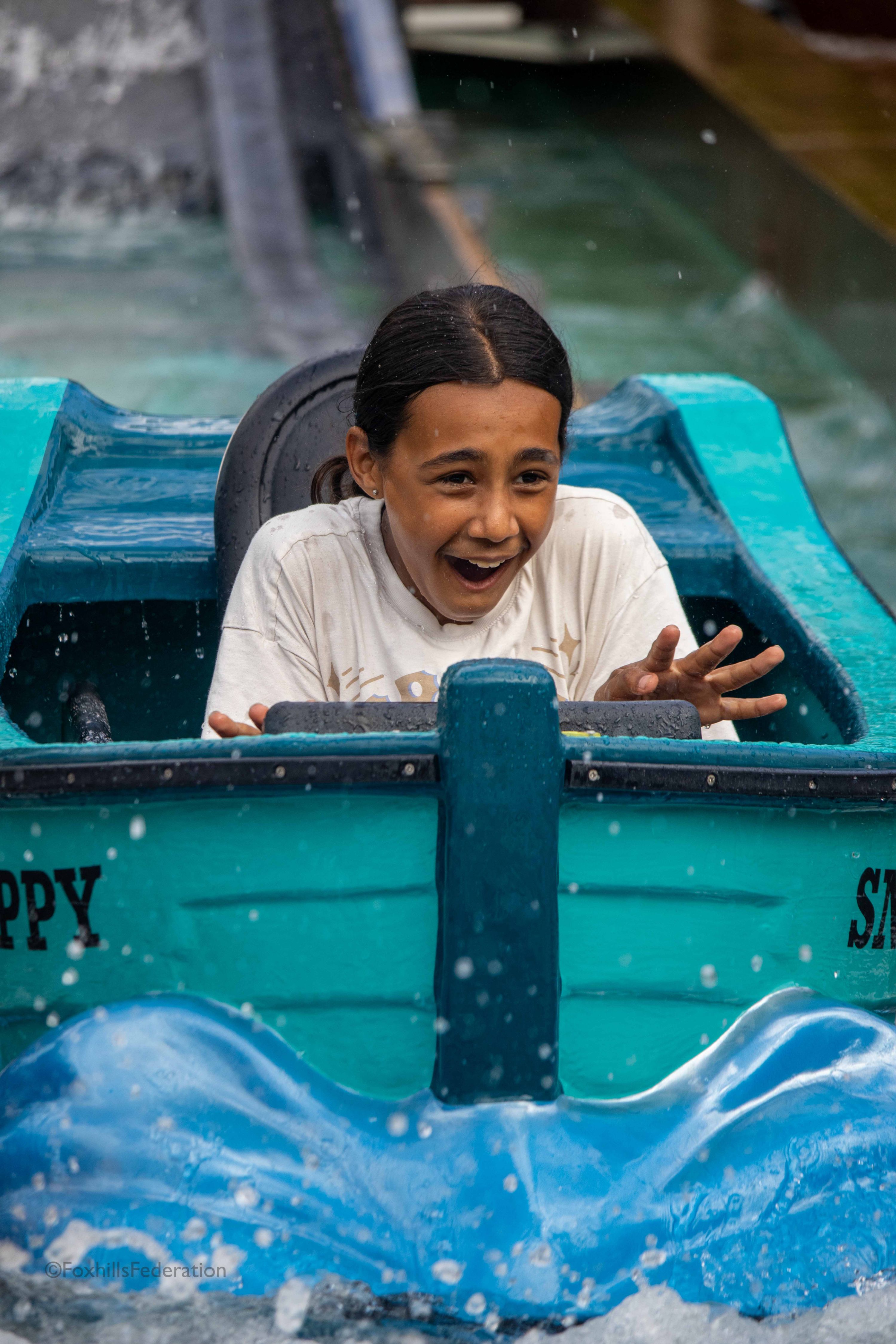 A girl gets splashed on the log flume