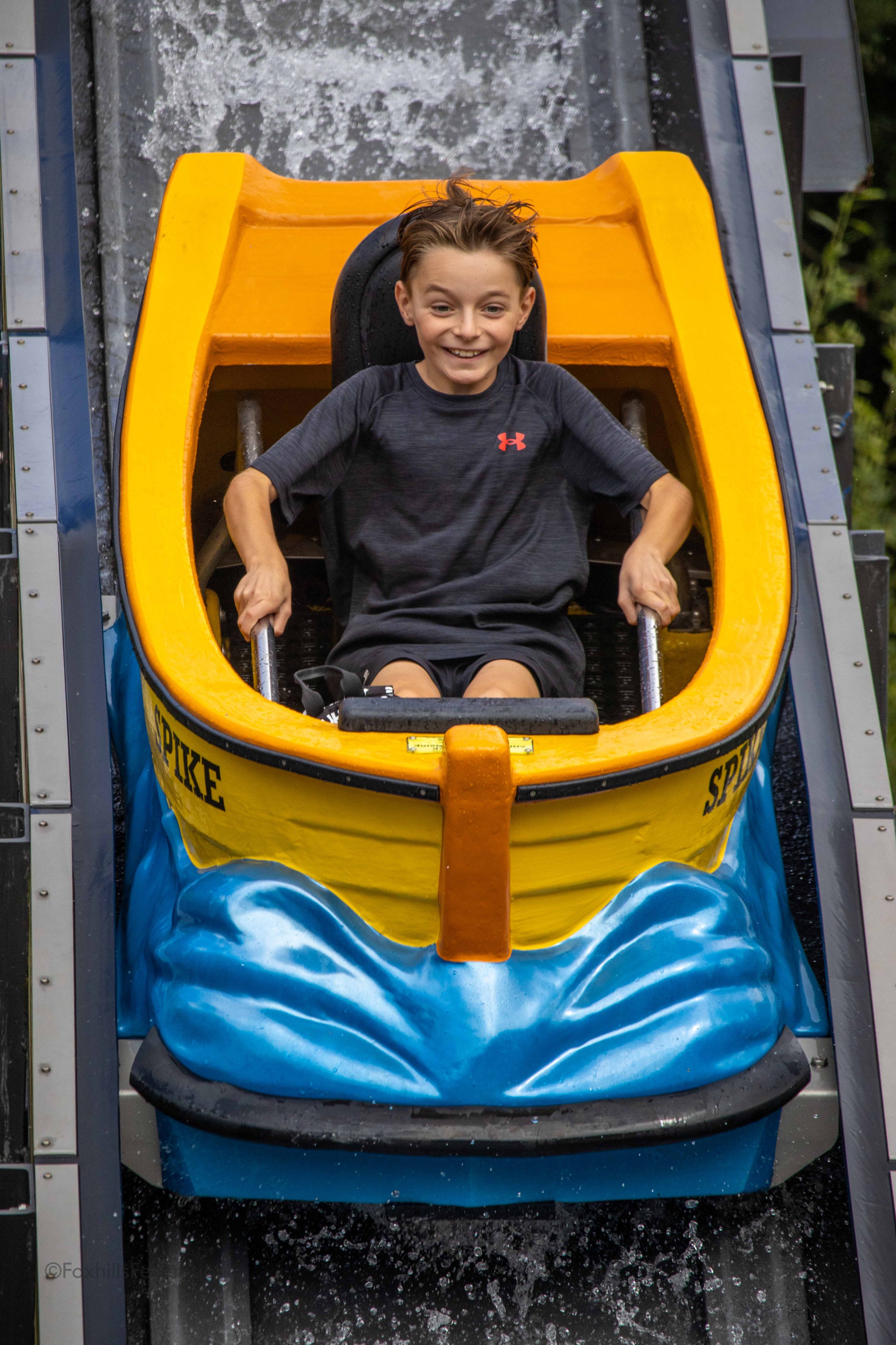 A boy goes down the log flume