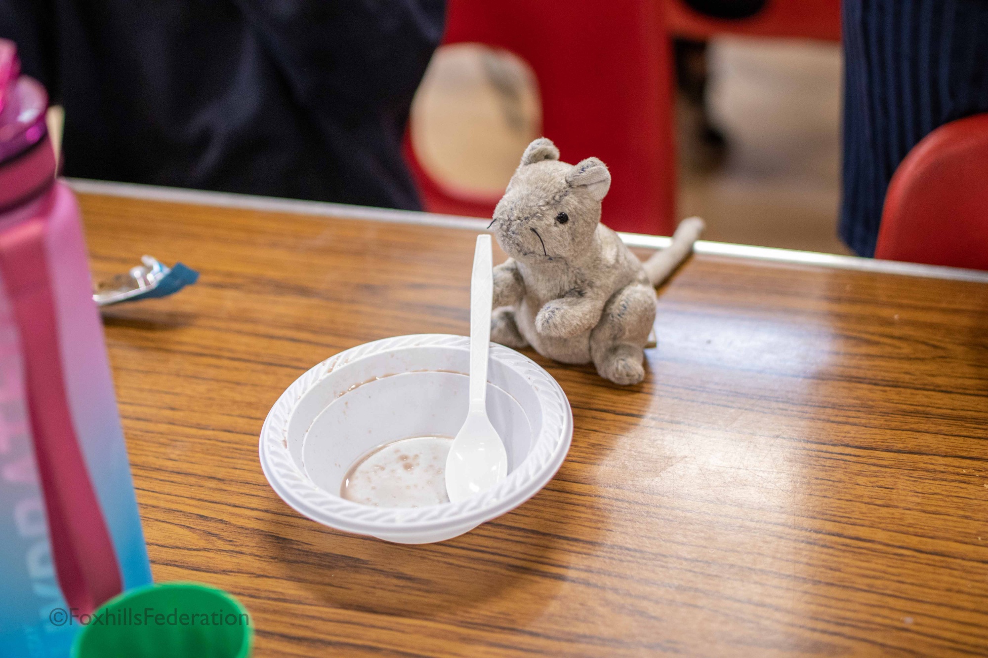 A mouse enjoys a bowl of cereal