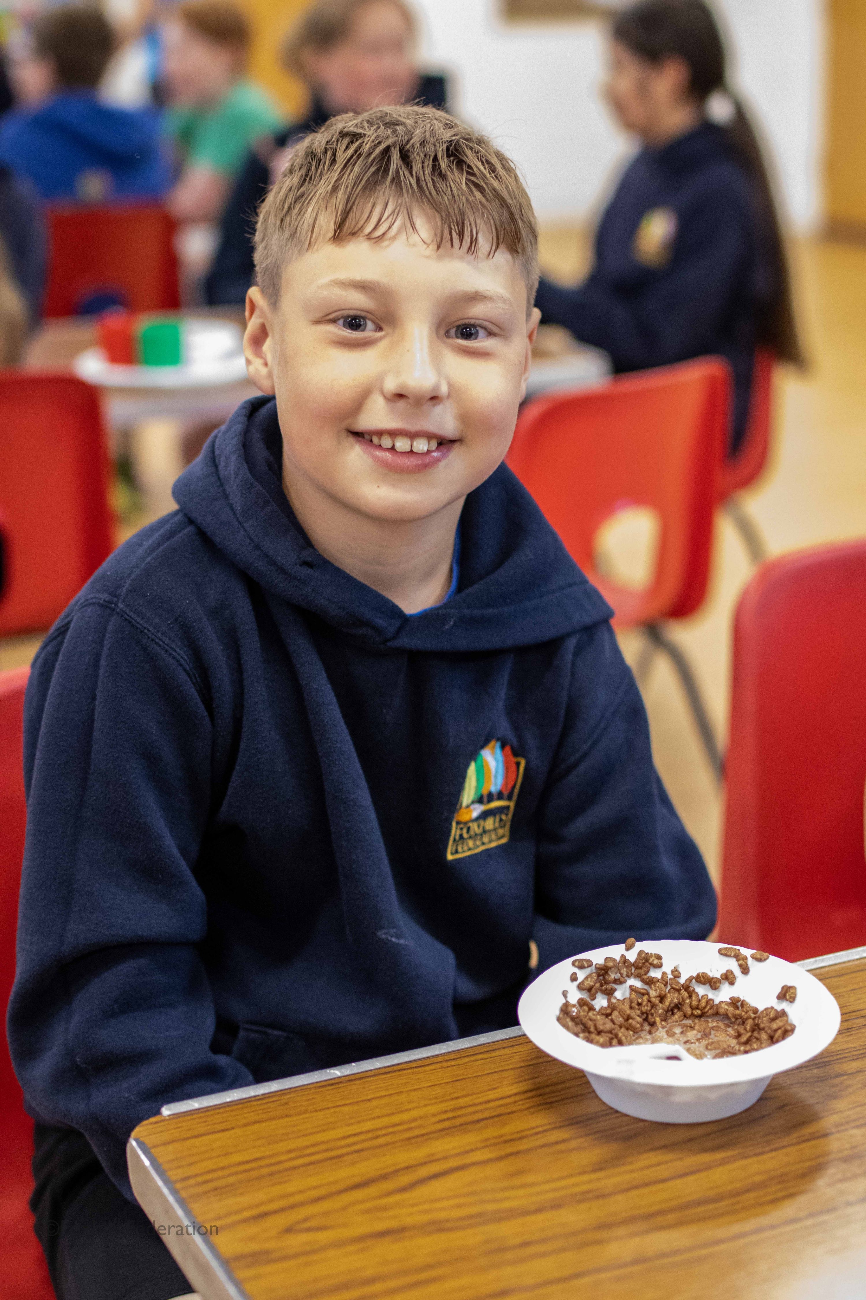 A boy enjoys a bowl of cereal 