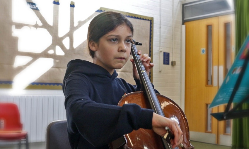 A girl plays a Cello at a Hampshire Music Service lesson